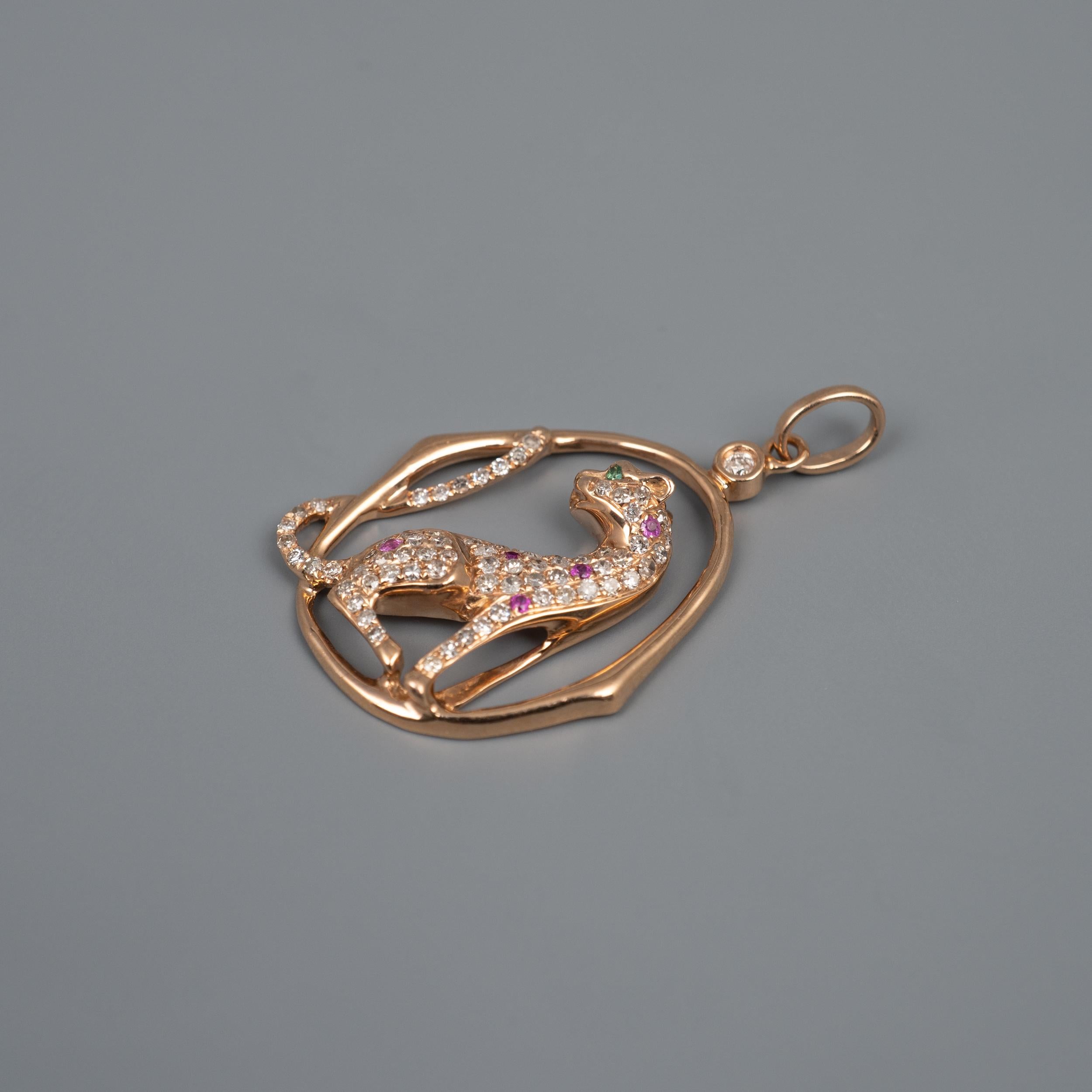 The fantastic and fine quality dimensional big cat is embellished with round cut diamonds with complimenting rubies and its eyes set with emeralds. A further single diamond is set to the top of the frame. A fabulous collection piece presented in
