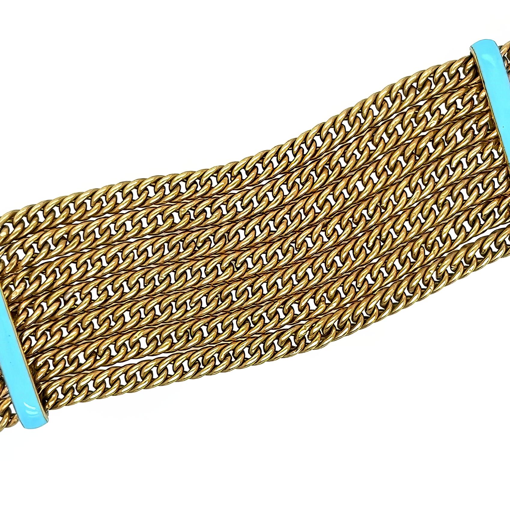 Ein Armband aus 15 Karat Gelbgold und Emaille.  Das Design besteht aus sieben Gliederketten, die von zwei hellblauen Emaille-Abstandshaltern unterbrochen werden.  Länge etwa 7 Zoll.  Bruttogewicht etwa 28.70 Gramm.