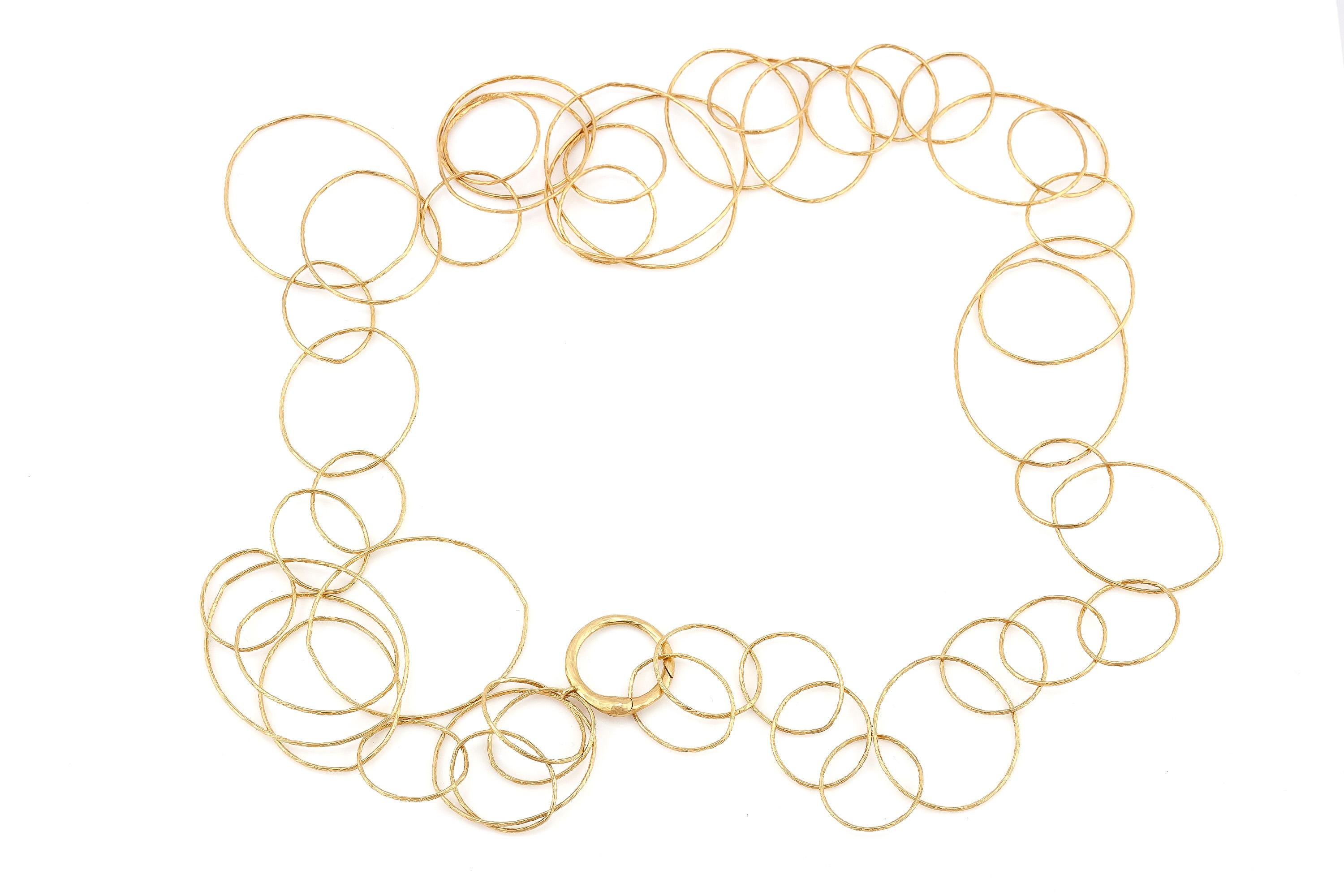 The beautiful gold link necklace is from the Hammered CIrcles Collection by Paloma Picasso for celebrating her 30 years with Tiffany & Co.
Finely crafted in 18k yellow gold.
50 grams.
52 inches long.