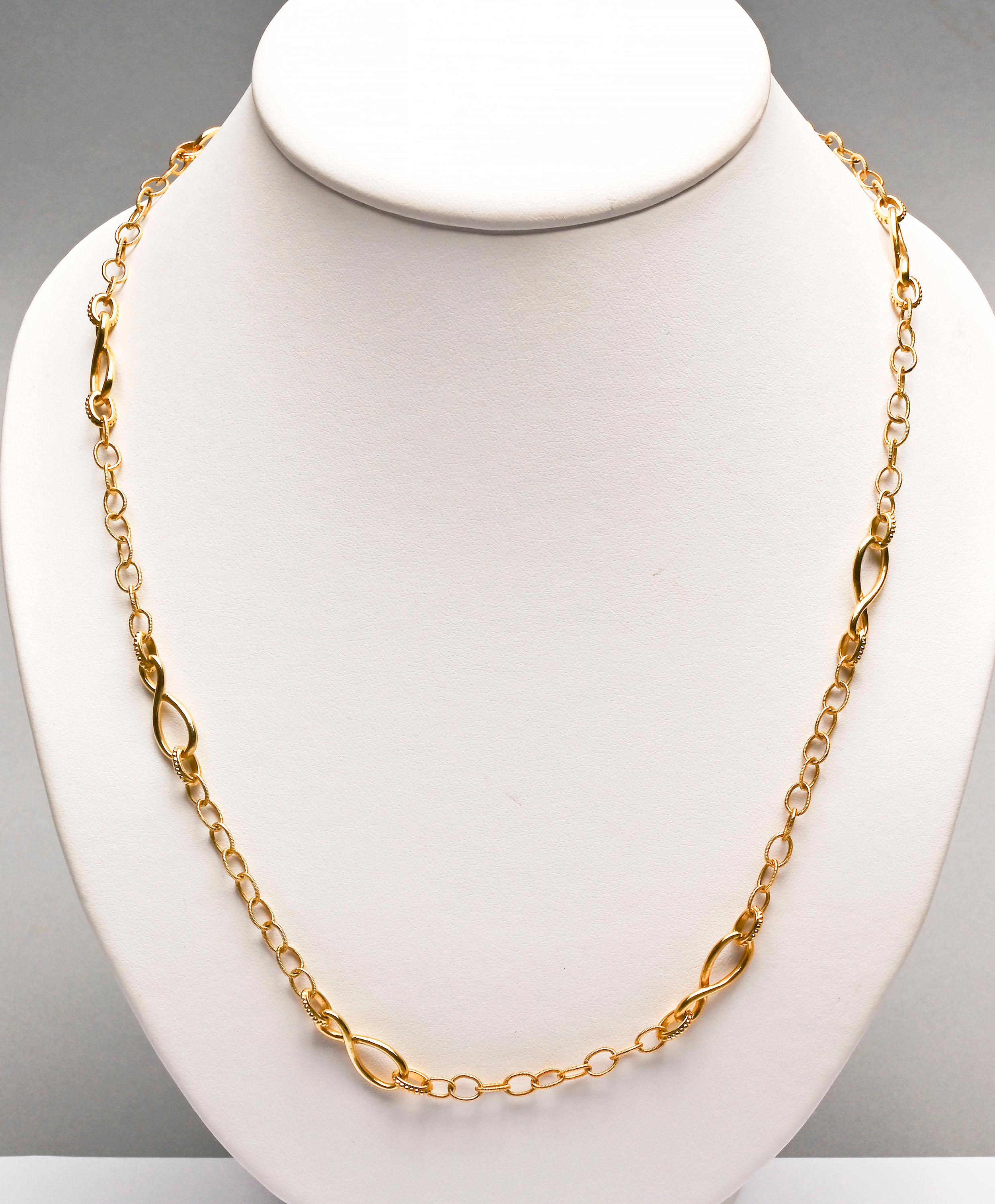 This long 18 karat gold necklace is made of three different links. Largest is a figure eight that measures 1/4
