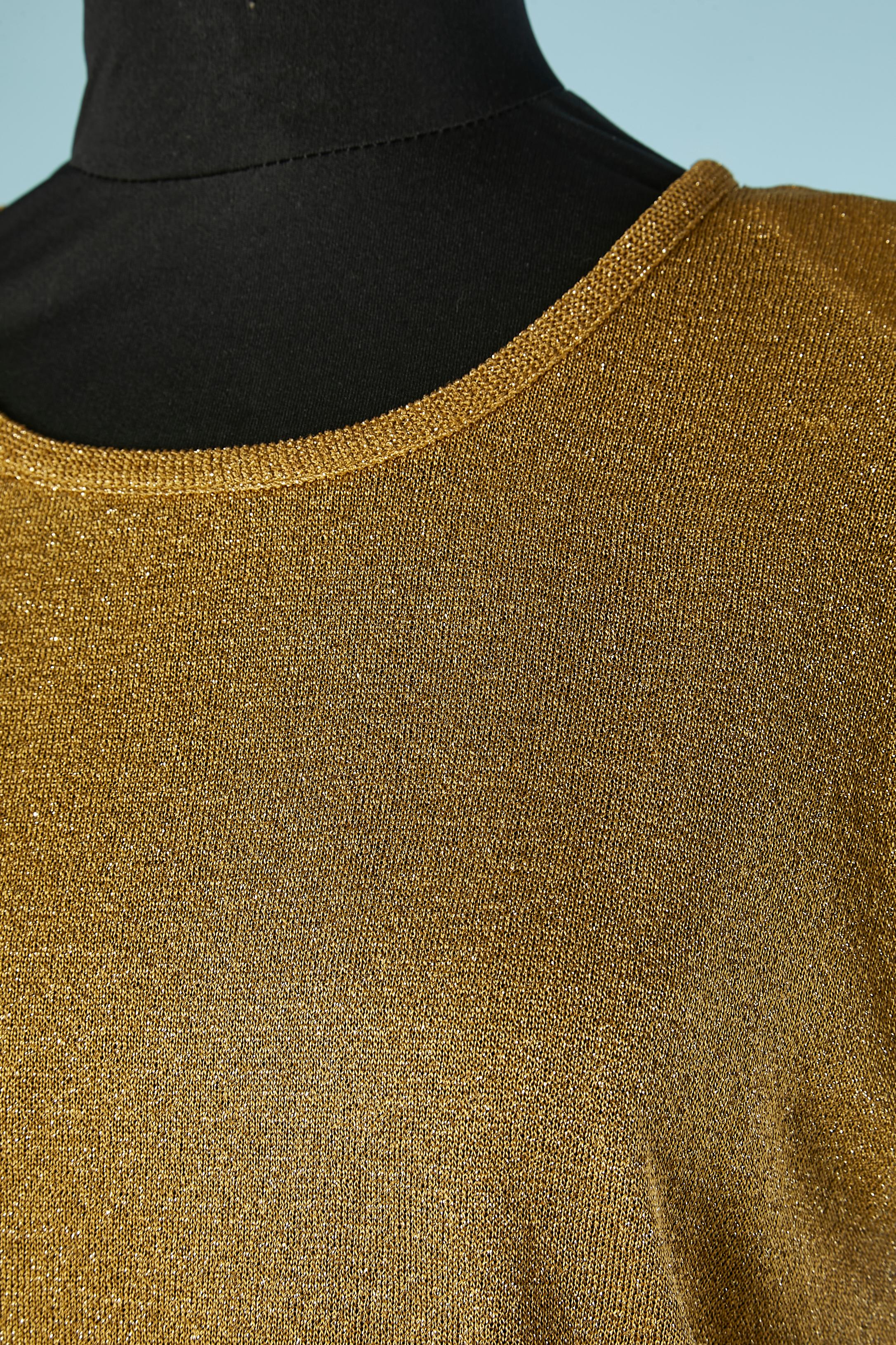 Gold lurex knit top. Shoulder pads. 
Fabric composition: 84% rayon, 16% polyester 
SIZE 44( It 10 (Us) 