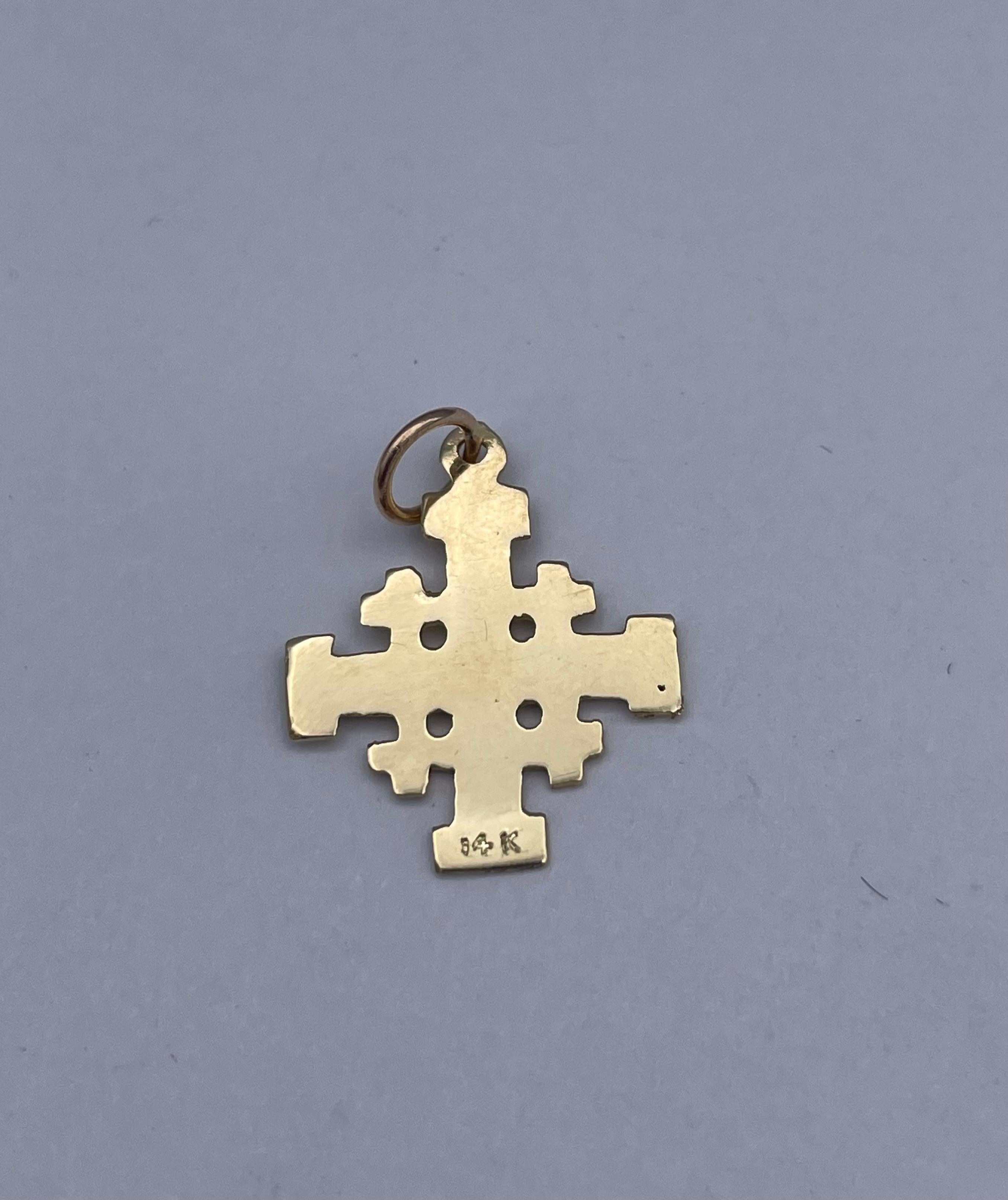 Small intricate maltese cross.  Set with four small crosses and engraved 