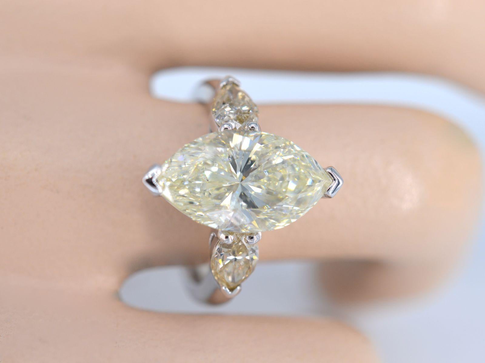 The golden ring described is a truly exceptional piece of jewelry, featuring a marquise cut diamond at its center that boasts an impressive size of 5.45 carats. This type of diamond cut is renowned for its unique shape, which combines pointed ends