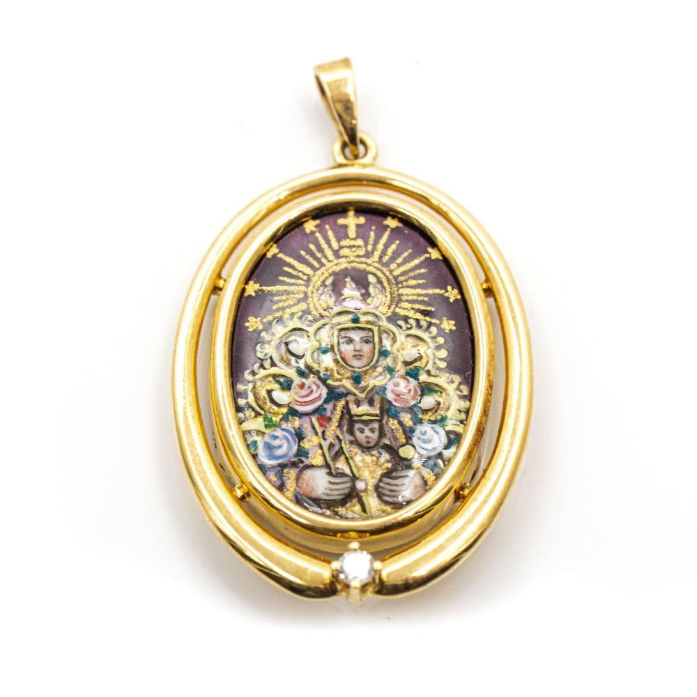 Gold Medal of the Virgin of Montserrat, with fire enamel technique.  18kt Yellow Gold  1x Brilliant Cut Diamond weighing 0.06cts in G/VS Quality  8,40 grams  Solid  Measures: 4,0cm length (including ring) and 2,5 cm width  Brand new product  Ref.: