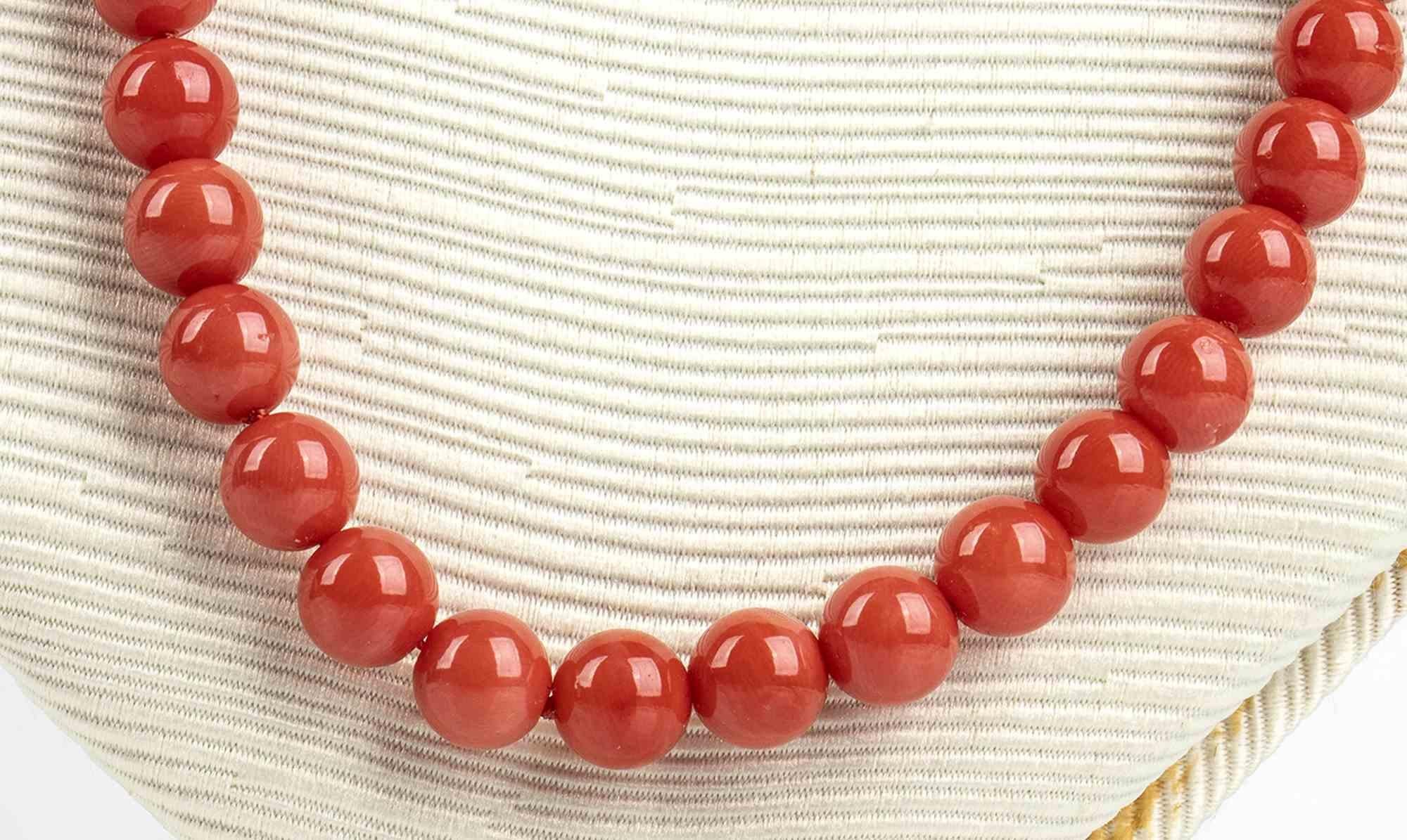 Mediterranean coral and diamonds necklace

One strand of Mediterranean coral beads (corallium rubrum), 18k white gold clasp set with brilliant cut diamonds ca. 0.04 ct, G, VS. Beads diameter 6-6.5 mm. Central bead diameter 12.5-13 mm. Stamped 