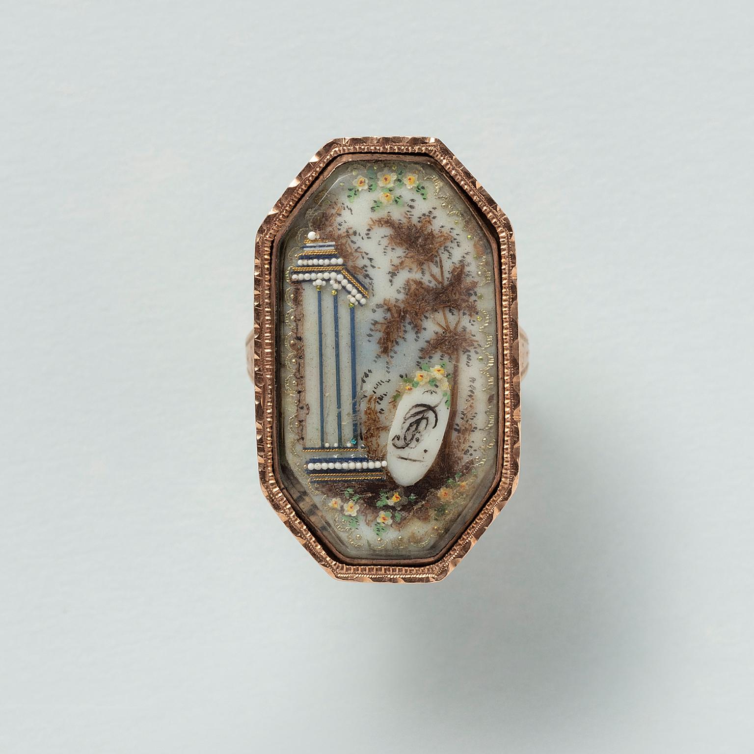 A large octagonal ring adorned with a Neo-Classical landscape. The scene features a classical colonnade and a gracefully waving tree, accompanied by a shield bearing the letters F and C. At first glance, one might wonder how such imagery could serve