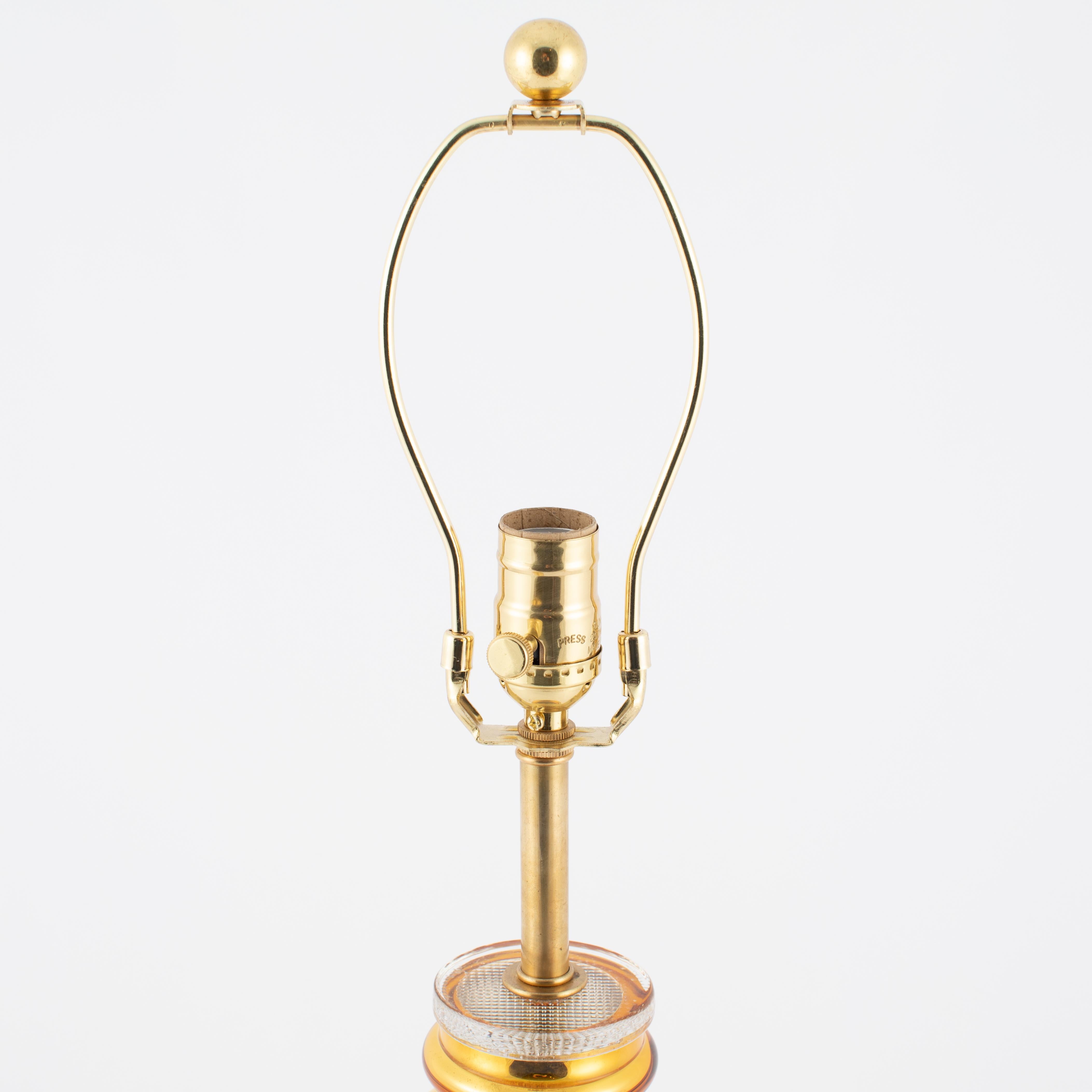 Gorgeous and shiny gold mercury glass TOTEM lamp by Johansfors Glasbruk of Sweden features a series of concentric rings getting smaller from bottom to top. This luminous lamp reflects everything around it, so the tone of the lamp will pick up on its