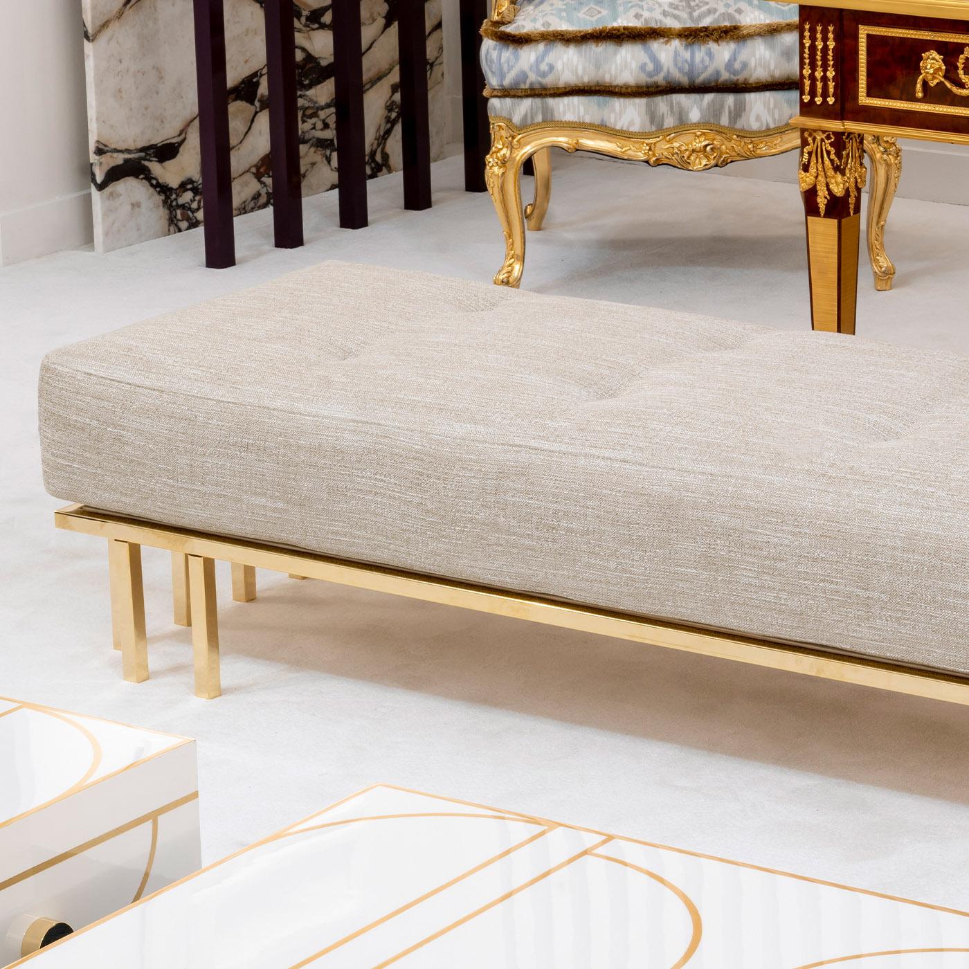 A clean and elegant design that embodies a timeless and sophisticated style, this bench will make for an exquisite addition to both private and contract interior settings. Handmade of gold-finished and chromed steel, it is upholstered with gray