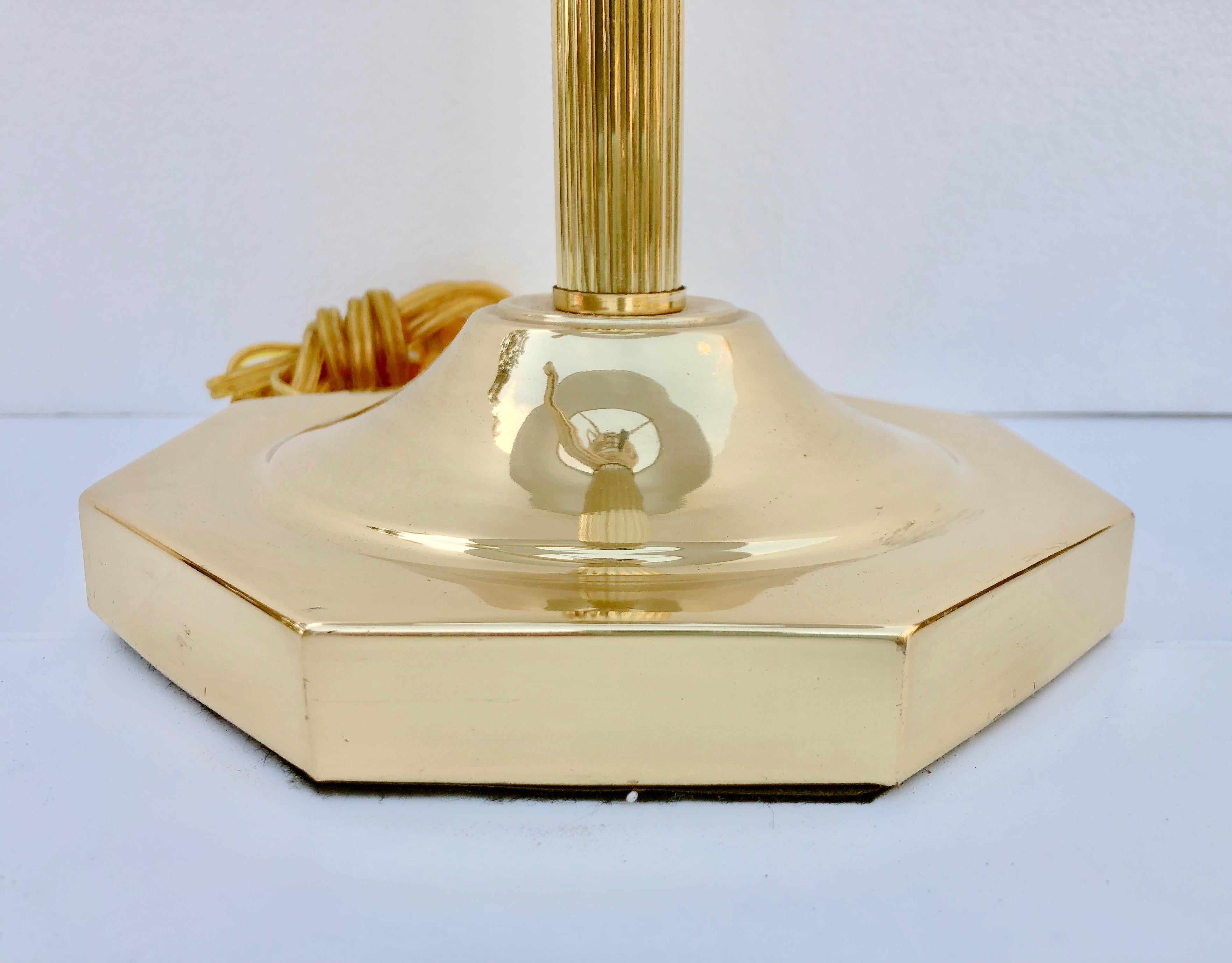 This is a wonderful gold metal desk or reading lamp with an arm that extends for easy adjustment. It has a gold circular finial and a solid octagonal base. It would add style to any desk, library or side table.

Lamp shade size H 5 x W 11.5.