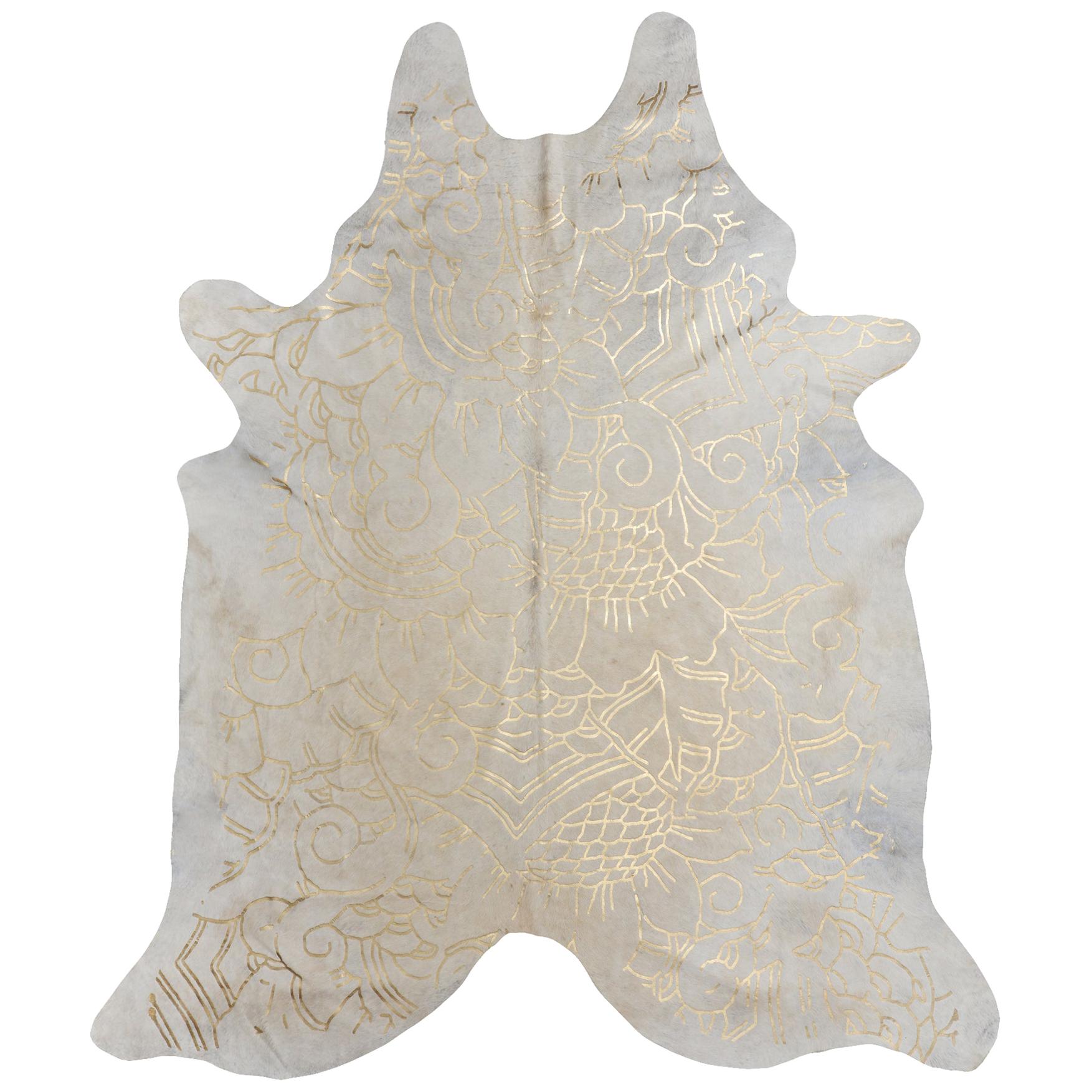 Alfombra de piel de vaca color crema con estampado Boho Batik metalizado dorado, mediana