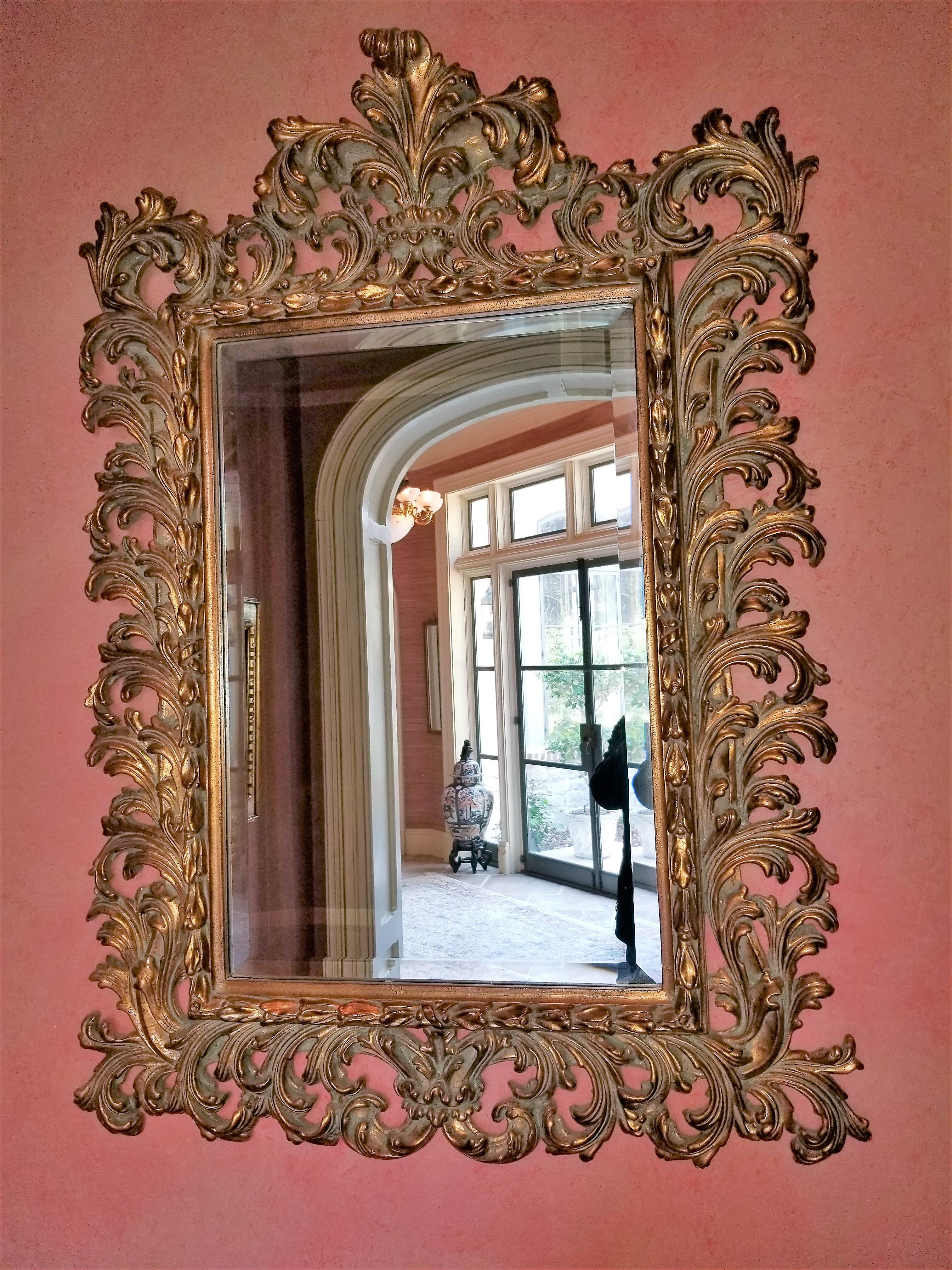 Miroir en bois doré décoré de rinceaux, 20e siècle.