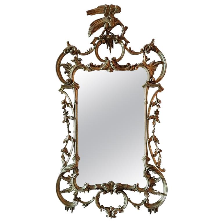 Miroir en bois doré décoré de volutes et d'un fleuron en phénix:: 20e siècle