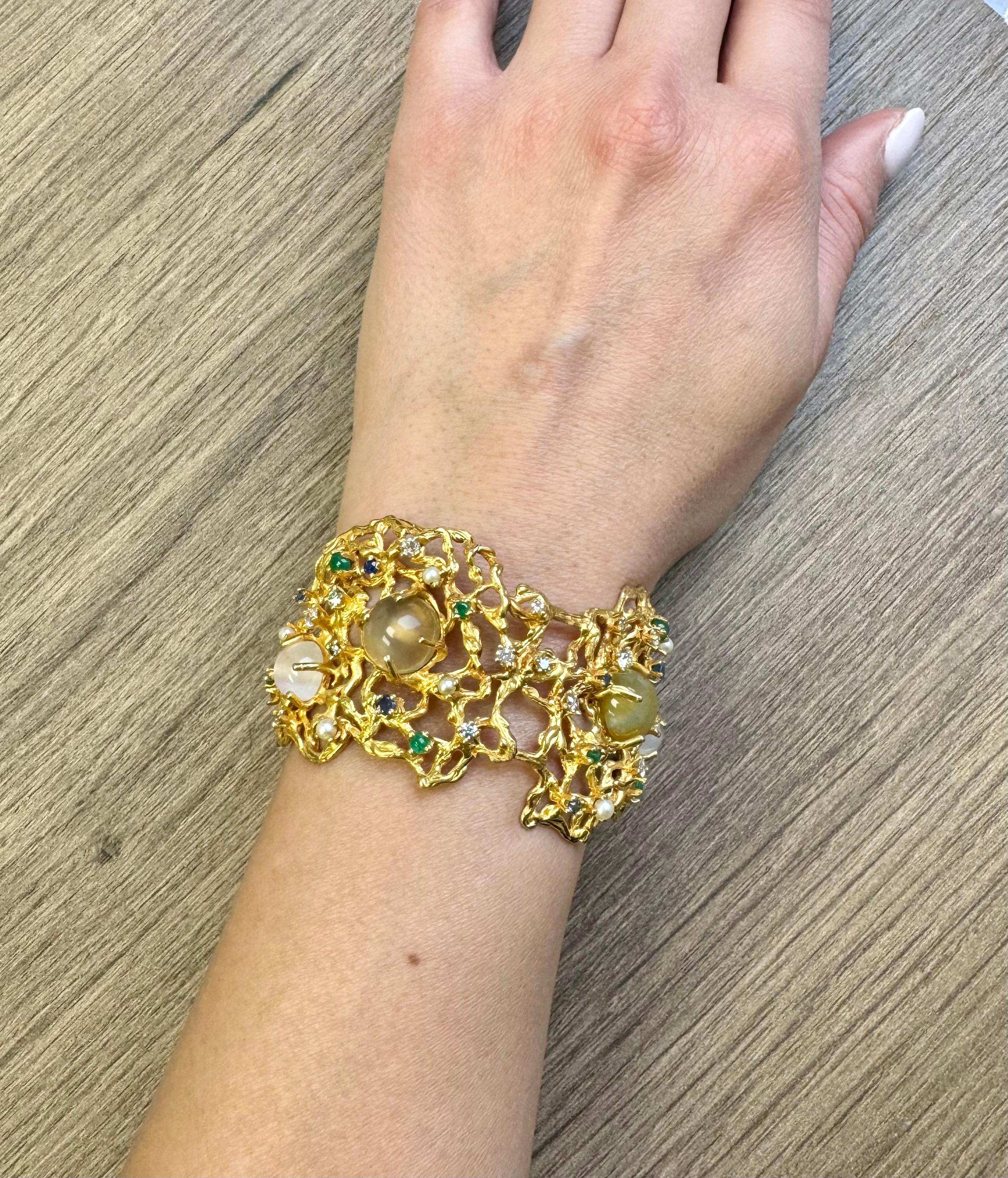 14 karat gold Bracelet with moonstones, emeralds, diamonds, sapphire, and cultured pearls.