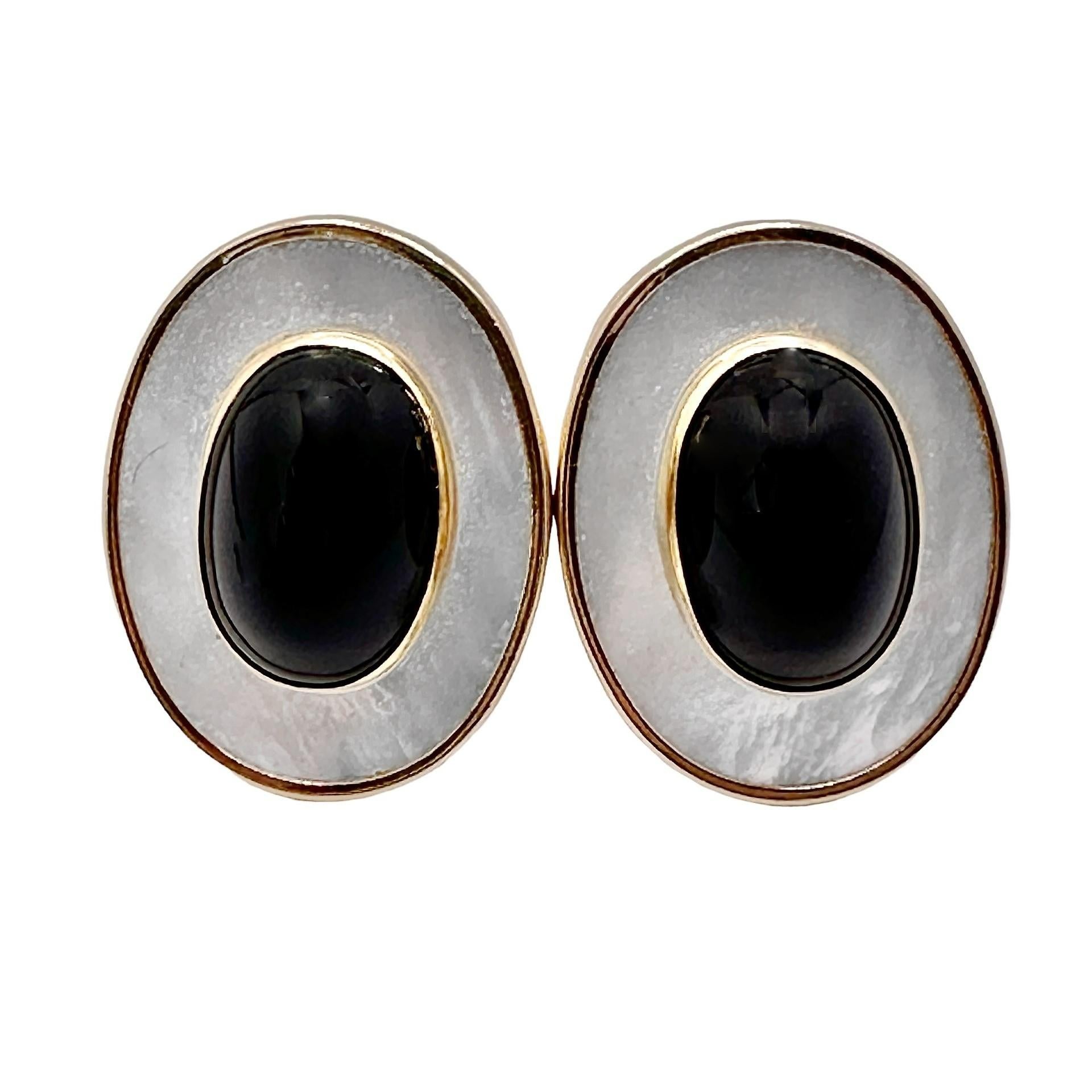This pair of very aesthetic and soundly constructed 14K yellow gold clip on earrings are truly captivating, with two onyx cabochons set in bezels on a background of vibrant mother of pearl. They are lightweight and comfortable to wear. Earrings