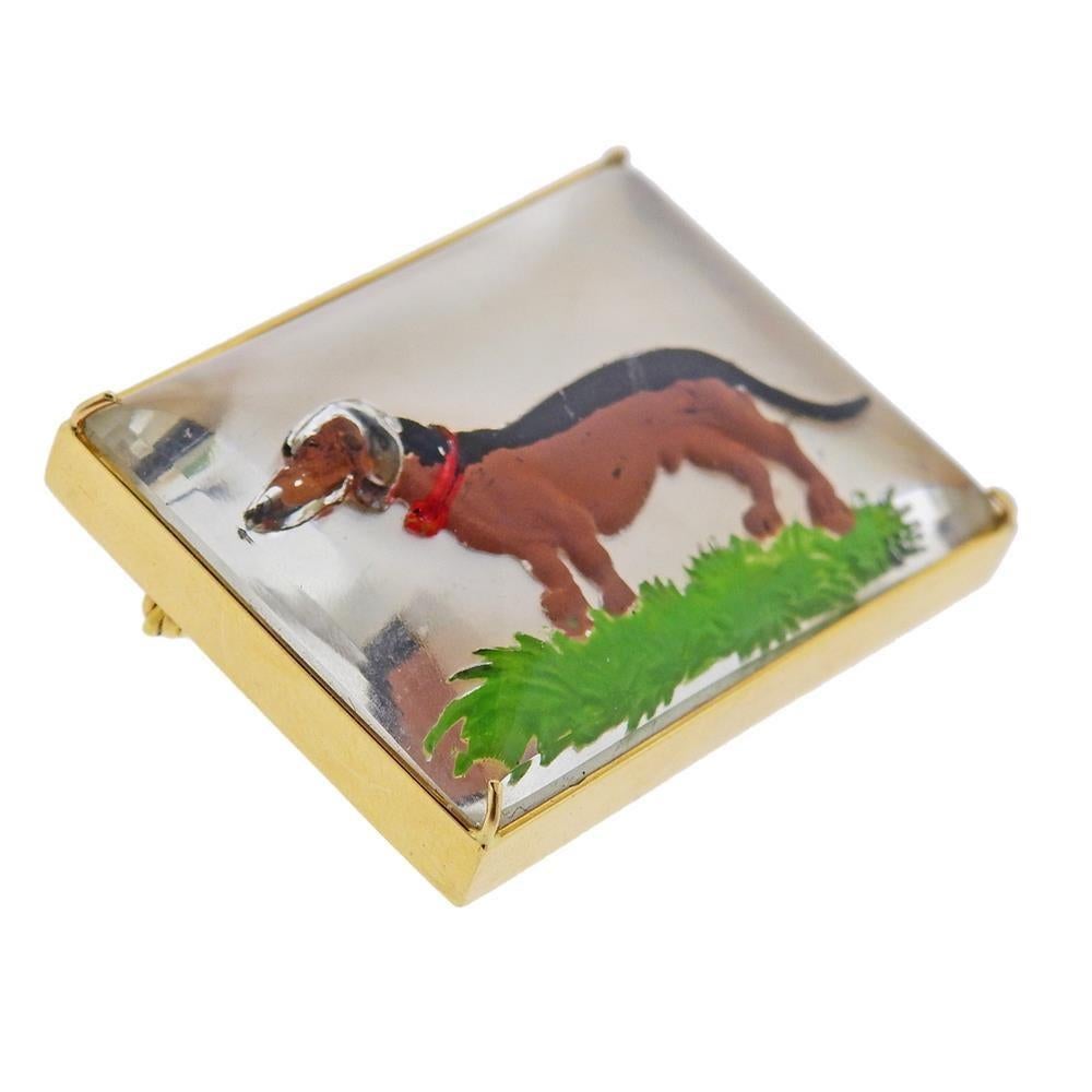 14k gold brooch, featuring dog reverse painting on a mother of pearl under a crystal top. MEASUREMENTS: 43mm x 33mm. Tested 14k. Weight 36.4 grams.PB-00778