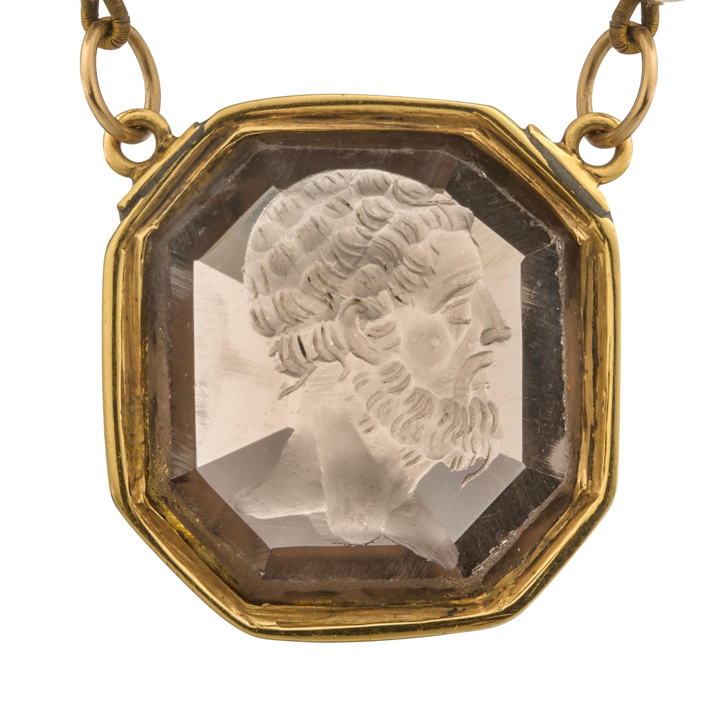 Gold-Mounted Smoky Quartz Intaglio Necklace, 19th century.
 
Measurements
    •    Intaglio (including mount): 2.6 × 2.5 cm
    •    Necklace length: 41 cm
 
A finely carved smoky quartz intaglio depicting the profile of a bearded man, his hair and