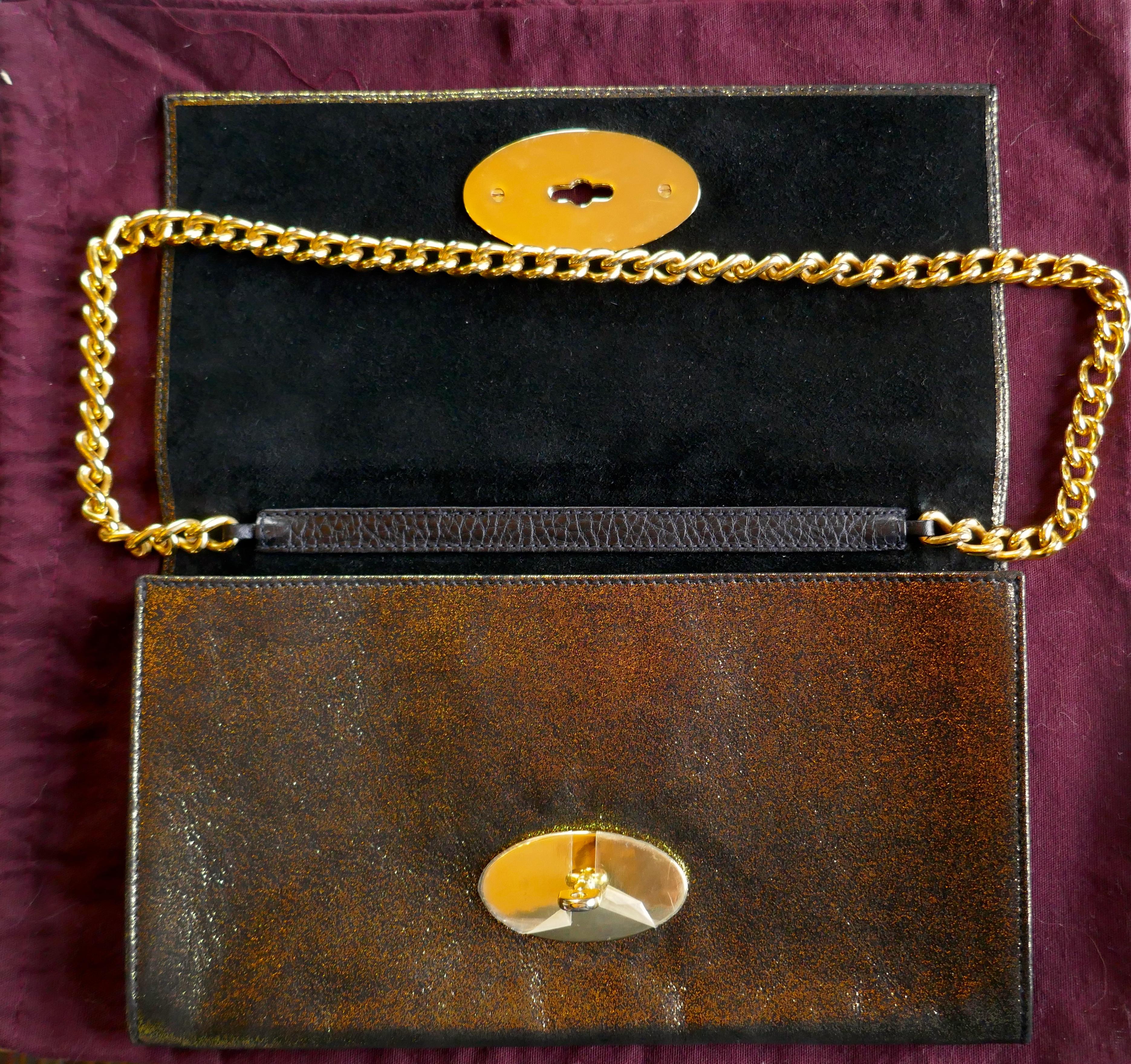 Gold Mulberry Evening Clutch or Chain Handle Bag

A superb and unusual bag, with this colour way you get a black & a gold evening bag in one
Heavy Gold (coloured) chain strap matching the letterbox latch
Very fine heavy quality, the bag has a soft