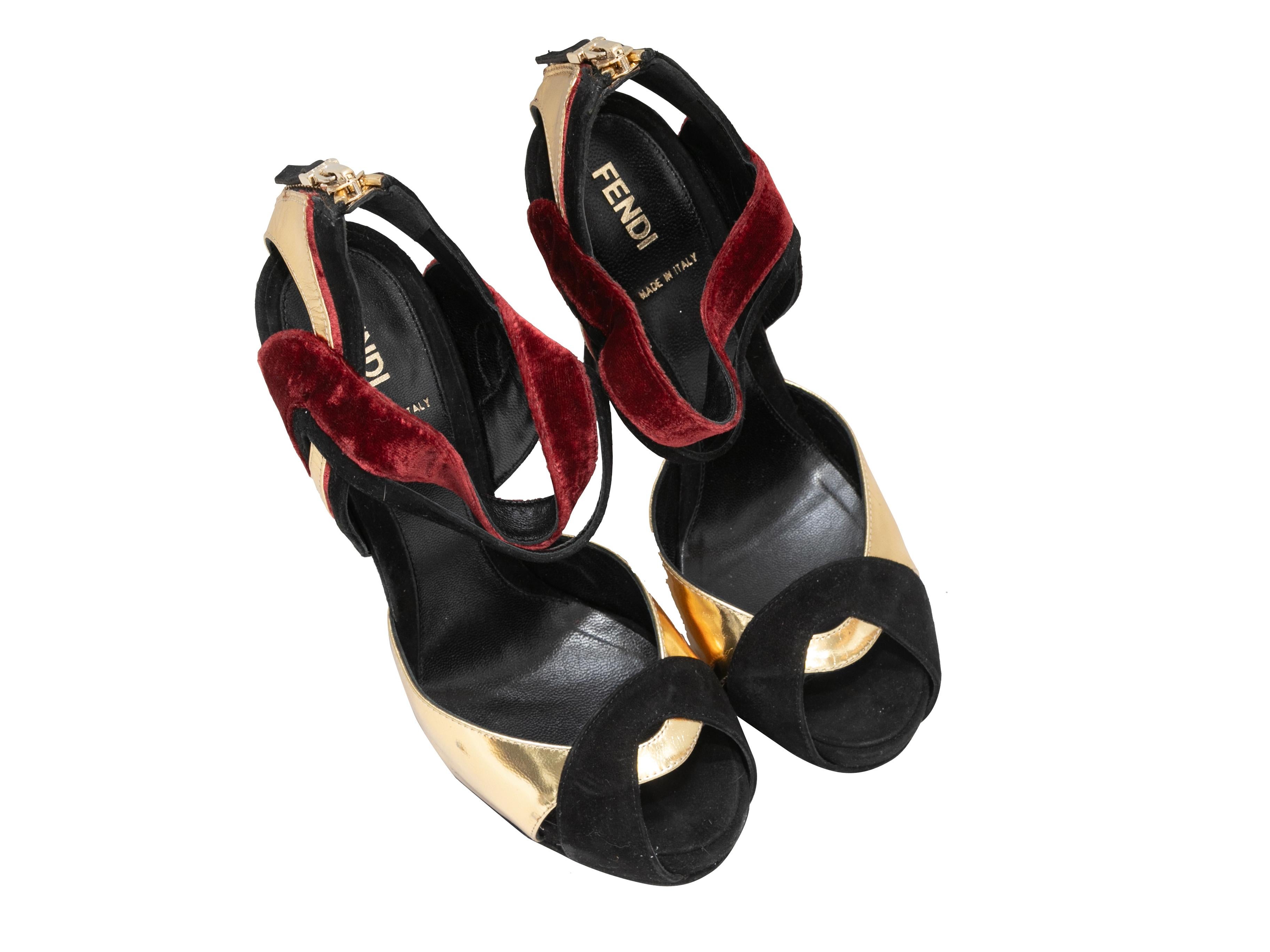 Gold, black, and burgundy leather and velvet cutout peep-toe platforms by Fendi. Zip closures at counters. 1.75