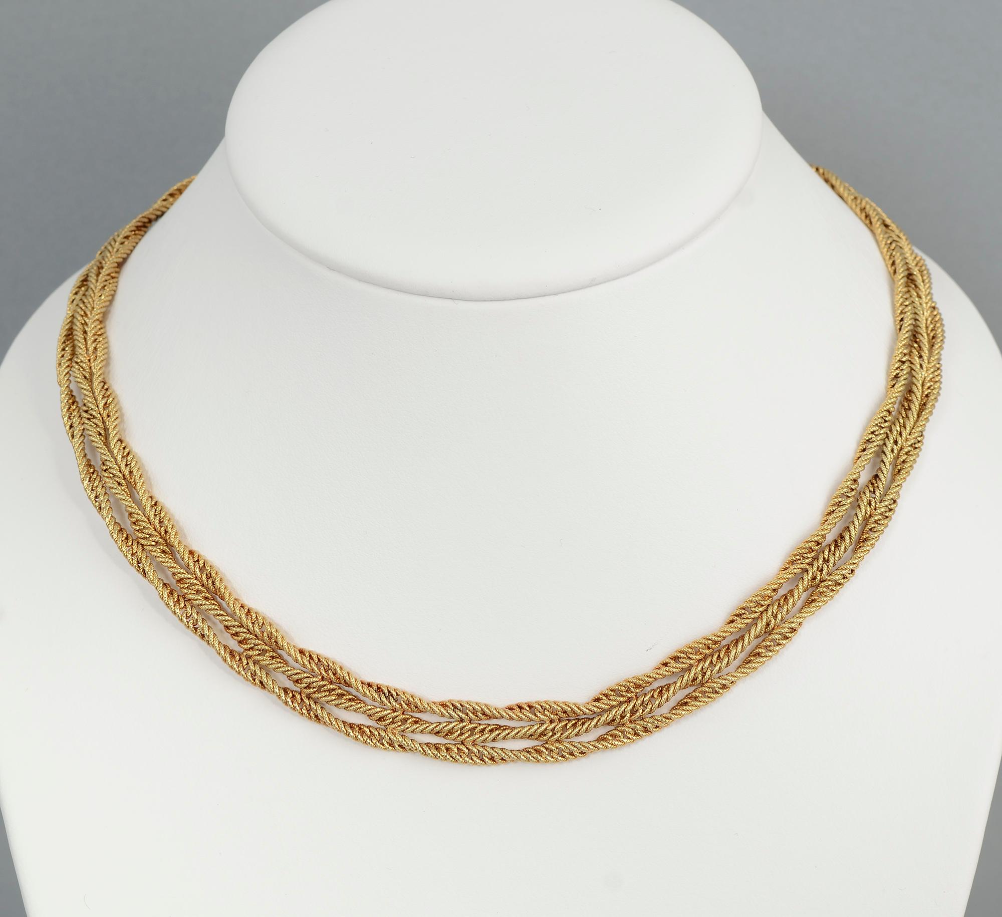 Unusual 14 karat gold choker necklace made of three double strands of  twisted gold in something of a foxtail pattern. The necklace is 17 1/2 inches long and 7/16