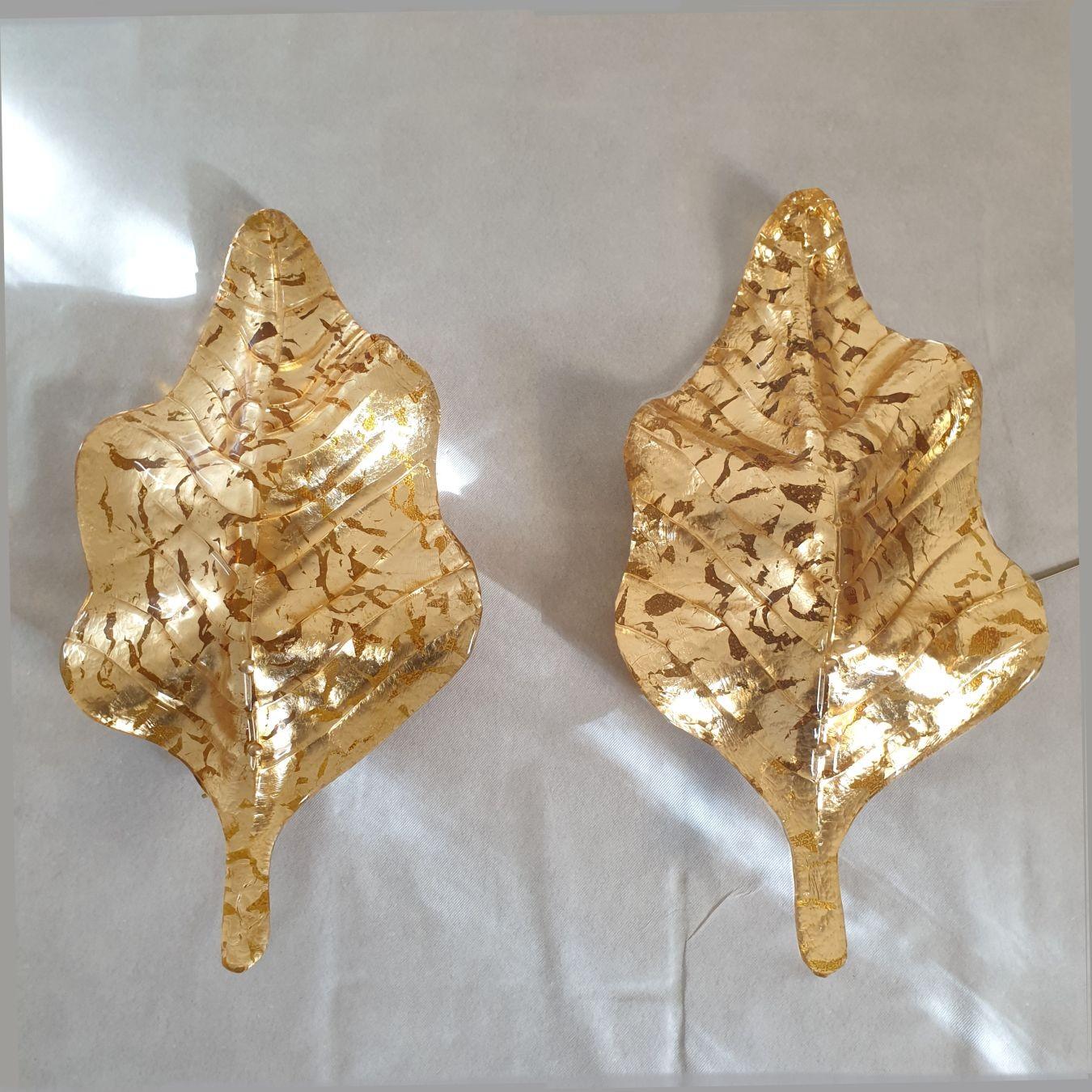 Pair of large Mid-Century Modern gold Murano glass sconces, Mazzega style, Italy 1980s.
Two pairs of sconces available - Set of four sconces.
Sold and priced by pair.
The large Italian sconces are made of a handmade Murano glass, with an amber color