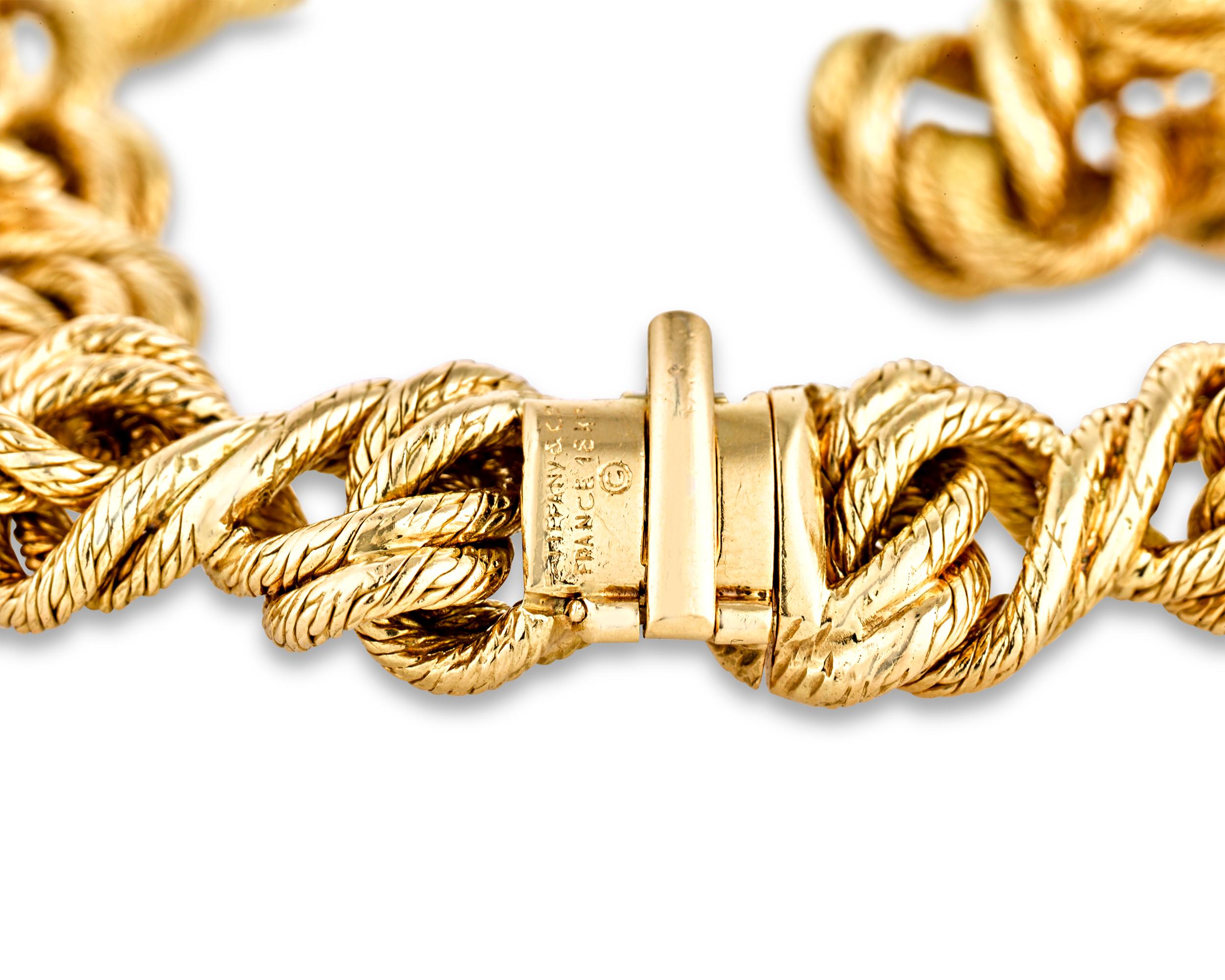 This elegant 18K yellow gold necklace by Georges L'Enfant for Tiffany & Co. features an intriguing rope-like appearance. The two-toned gold is textured and twisted, a signature technique for L'Enfant, creating depth and visual interest within the