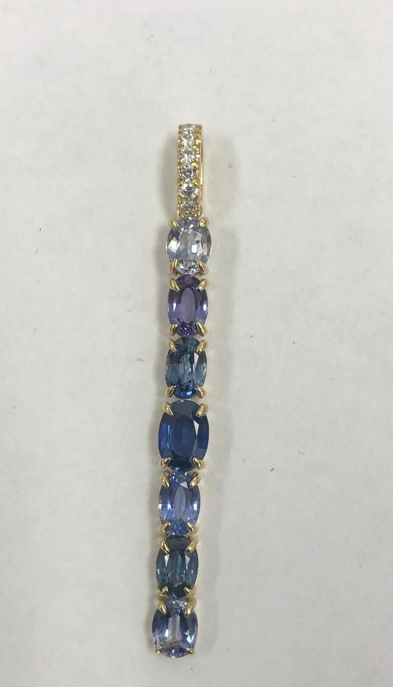 This Solid 18 Karat Yellow Gold is called the Blue Spell Necklace. It has 
3.52 Carats of Blue Ombre Ceylon Sapphire
and measures 2