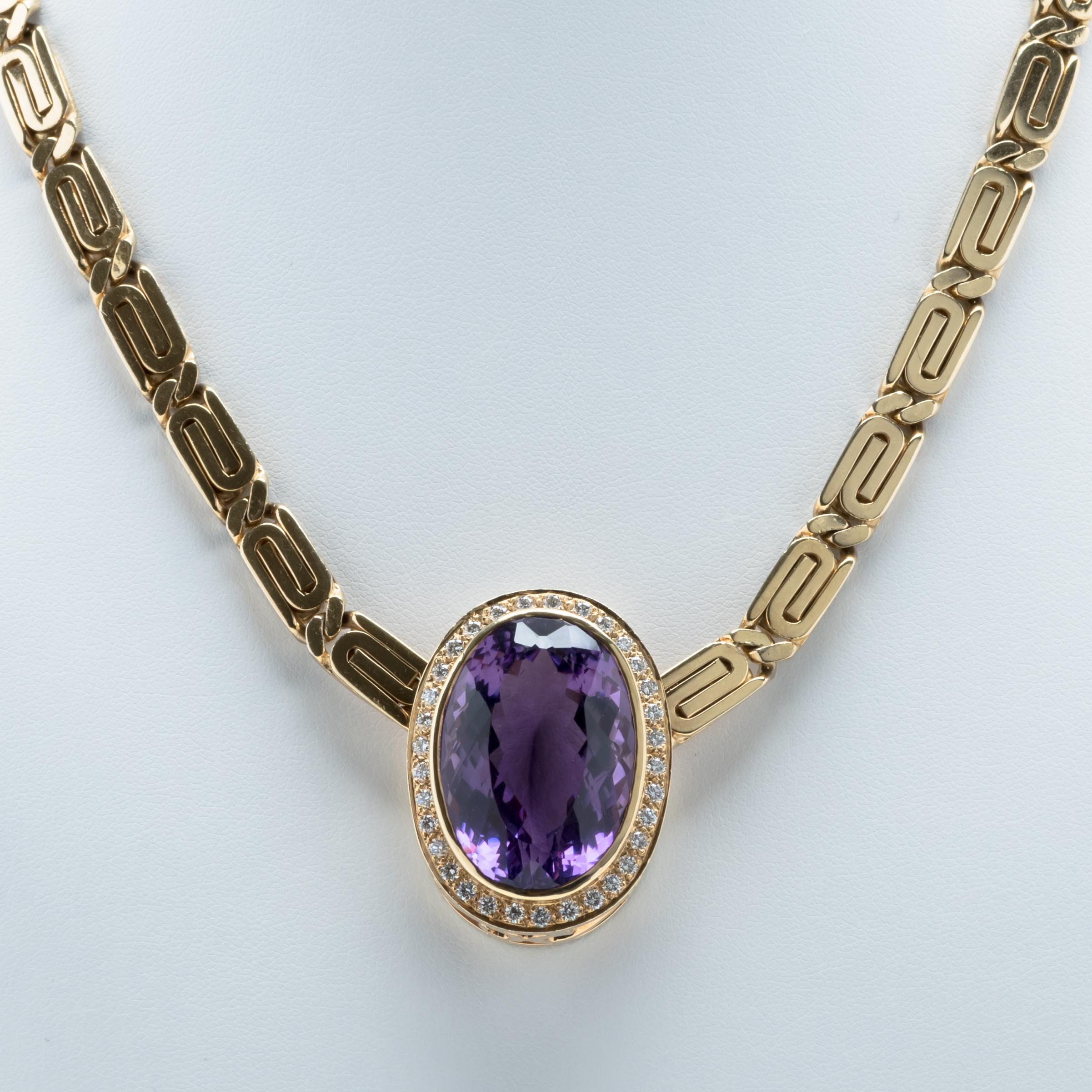 Italian 14 karat gold necklace with a heavy, geometric linked chain holding a magnificent large faceted oval amethyst pendant surrounded by diamonds. The clasp is stamped 14 K, Italy with hallmark.

Size: L: 19