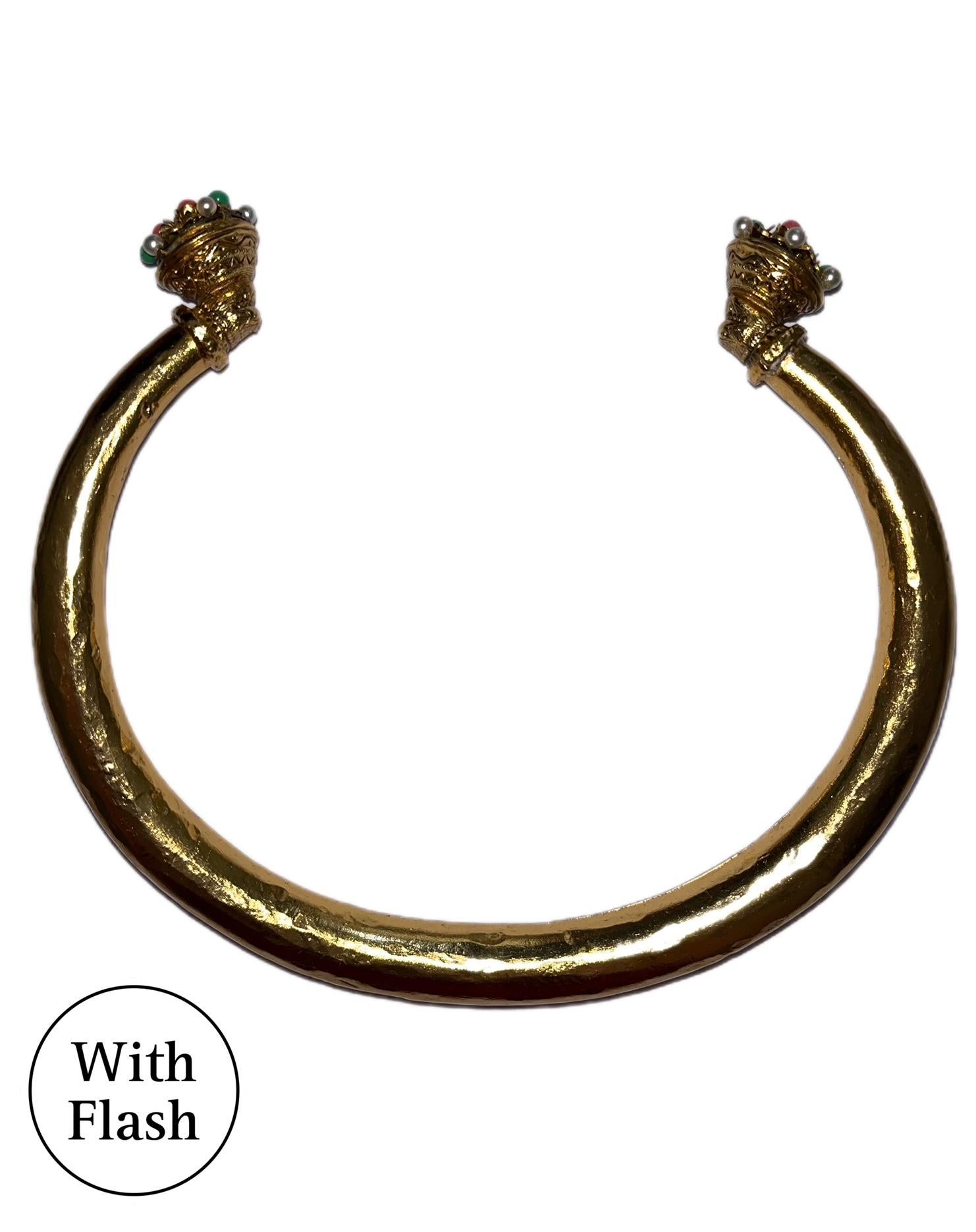 Questa splendida collana è un pezzo forte della casa di alta moda Jean-Louis Scherrer. La collana è composta da una fascia spessa e rigonfia di colore oro. L'originalità di questa collana vintage risiede nelle punte: l'apertura è ornata da perline