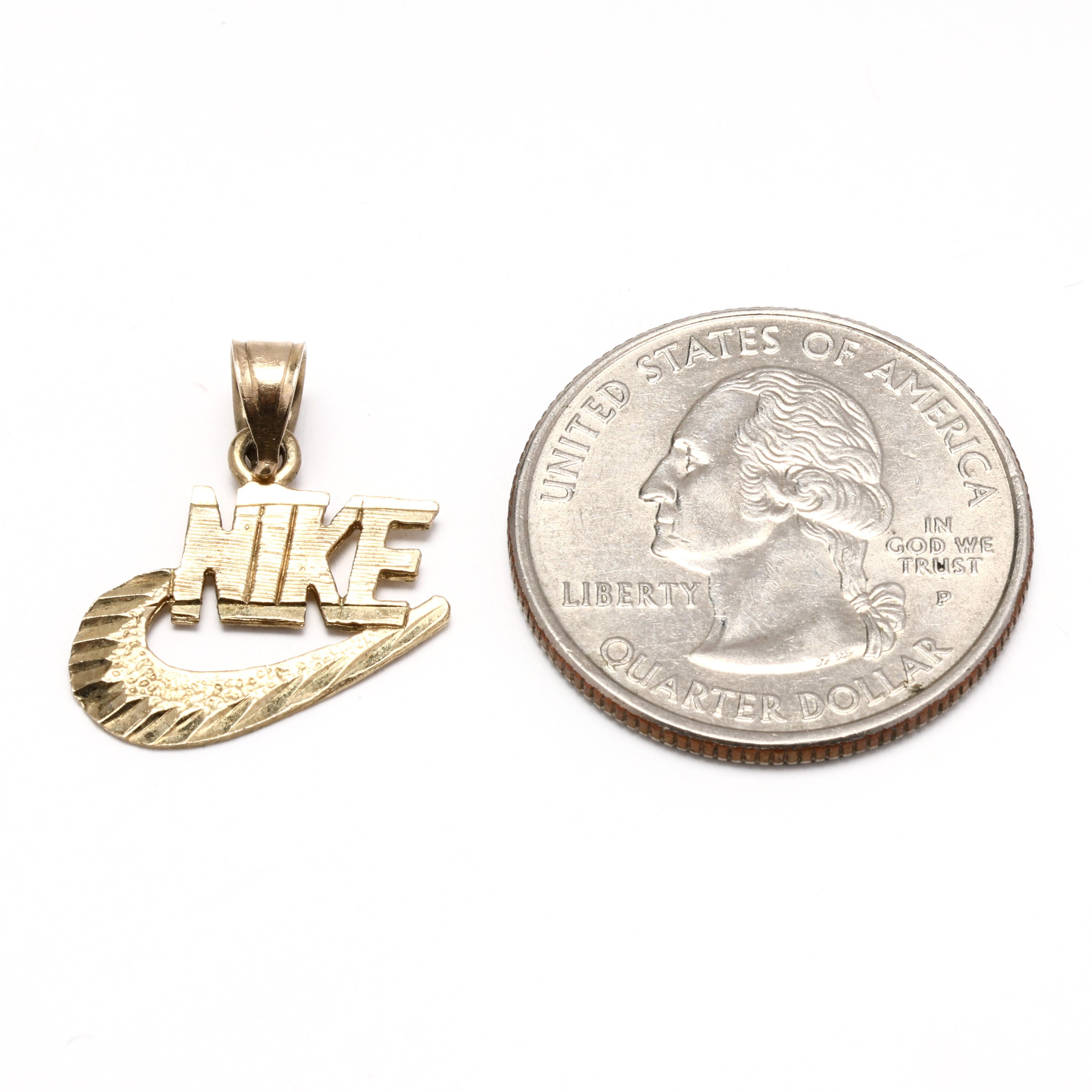 gold nike pendant