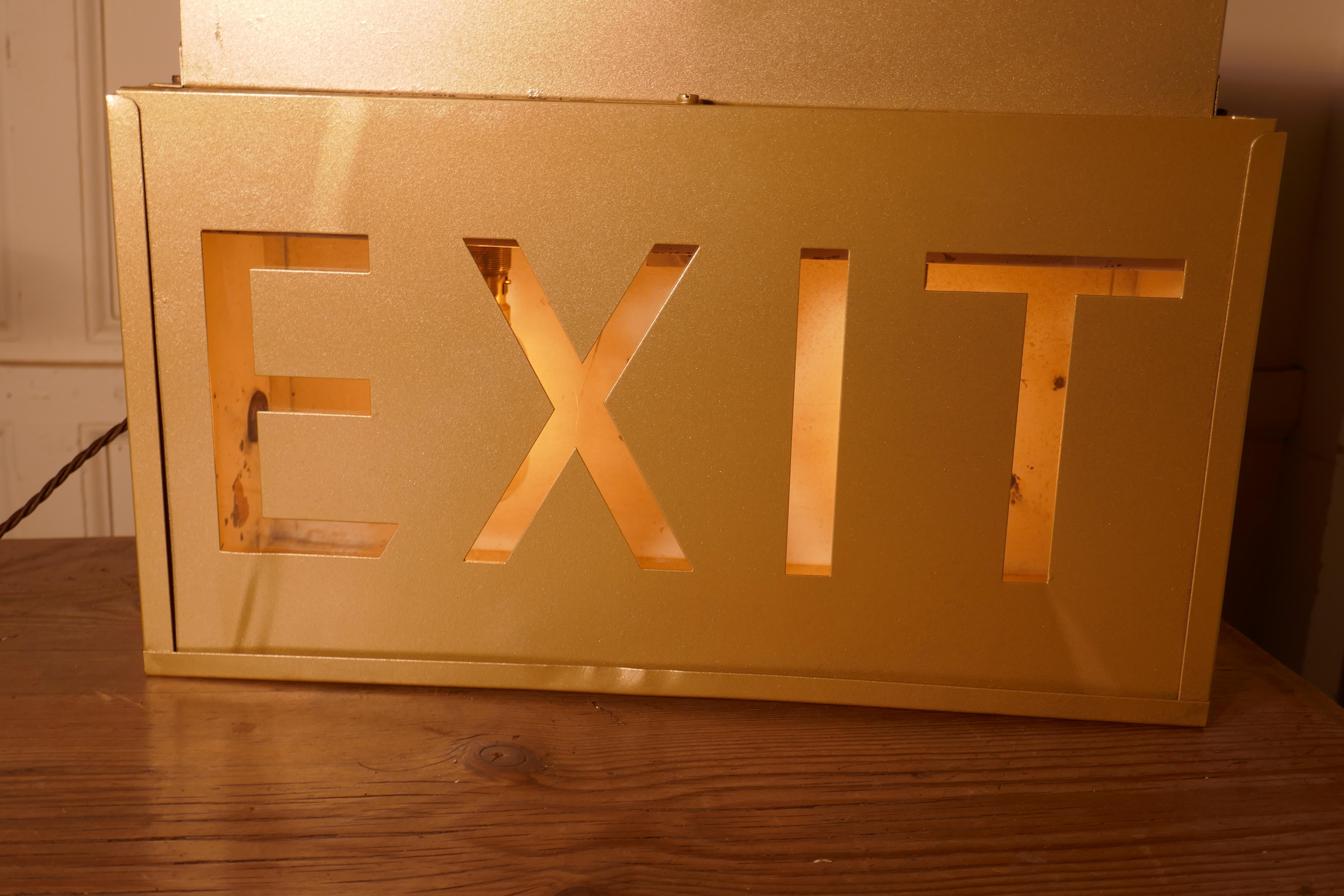 Gold Odeon Cinema EXIT Sign Electric Light 

A great piece of nostalgia, an Exit sign from a cinema, the light is fully working, when lit it lights the word EXIT 

In gilt metal the light has typical Odeon stepping at each side, the electric