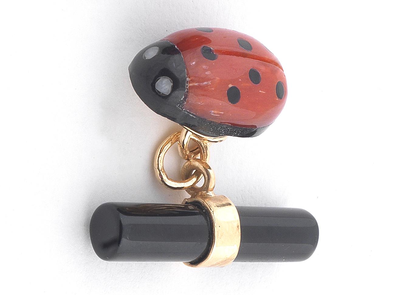 

Designed ad ladybug in corallum onyx and white agate eyes, with onyx baton terminals, length 2cm
