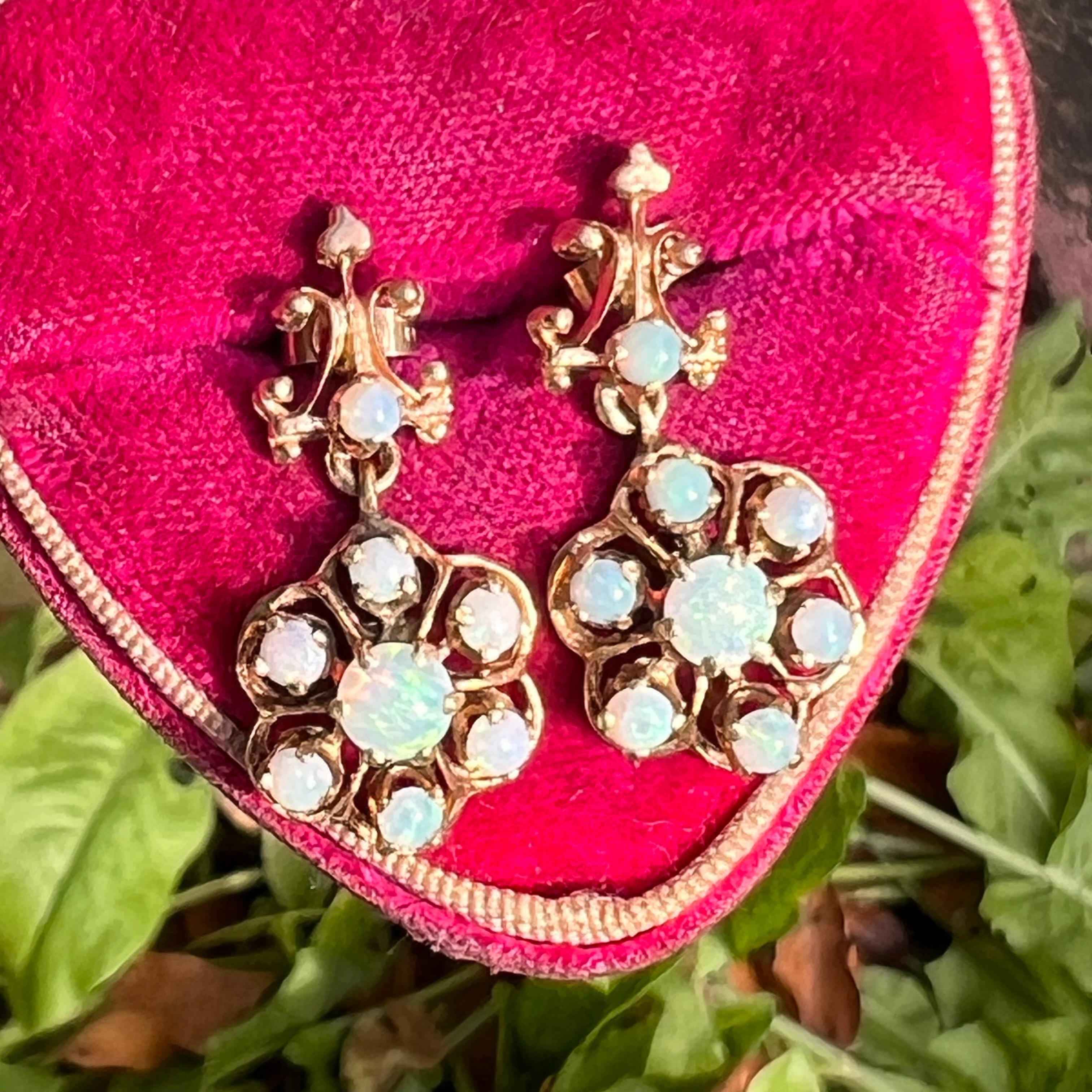 Vintage Victorian revival 14kt solid yellow gold dangle earrings with prong set opals .There are A large  fiery small opals is surrounded by 7 small opals .Earrings are for pireced ears .
Marked 14kt on back side .
Dates mid 20th century 

Materials