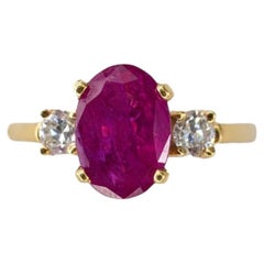 Gold Oval Ruby and Three-Stone Diamond Ring