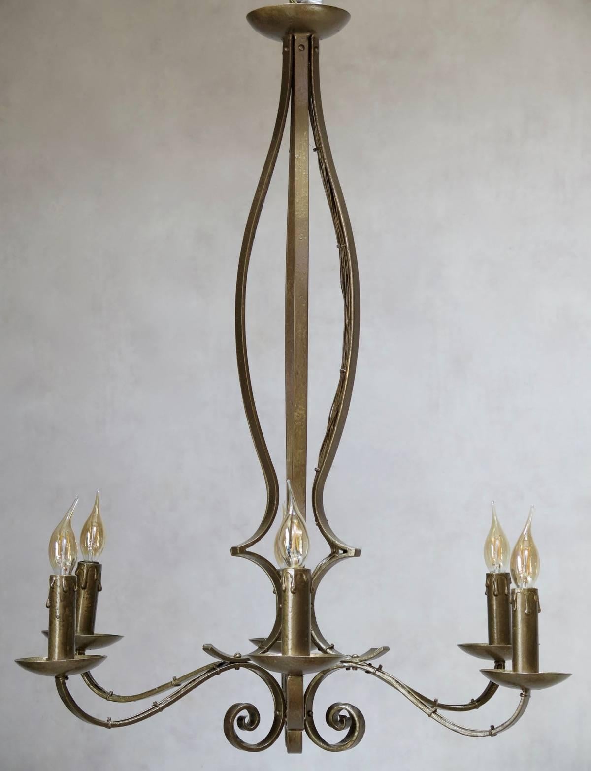 A 1940s Art Deco gold-painted iron chandelier with six lights.