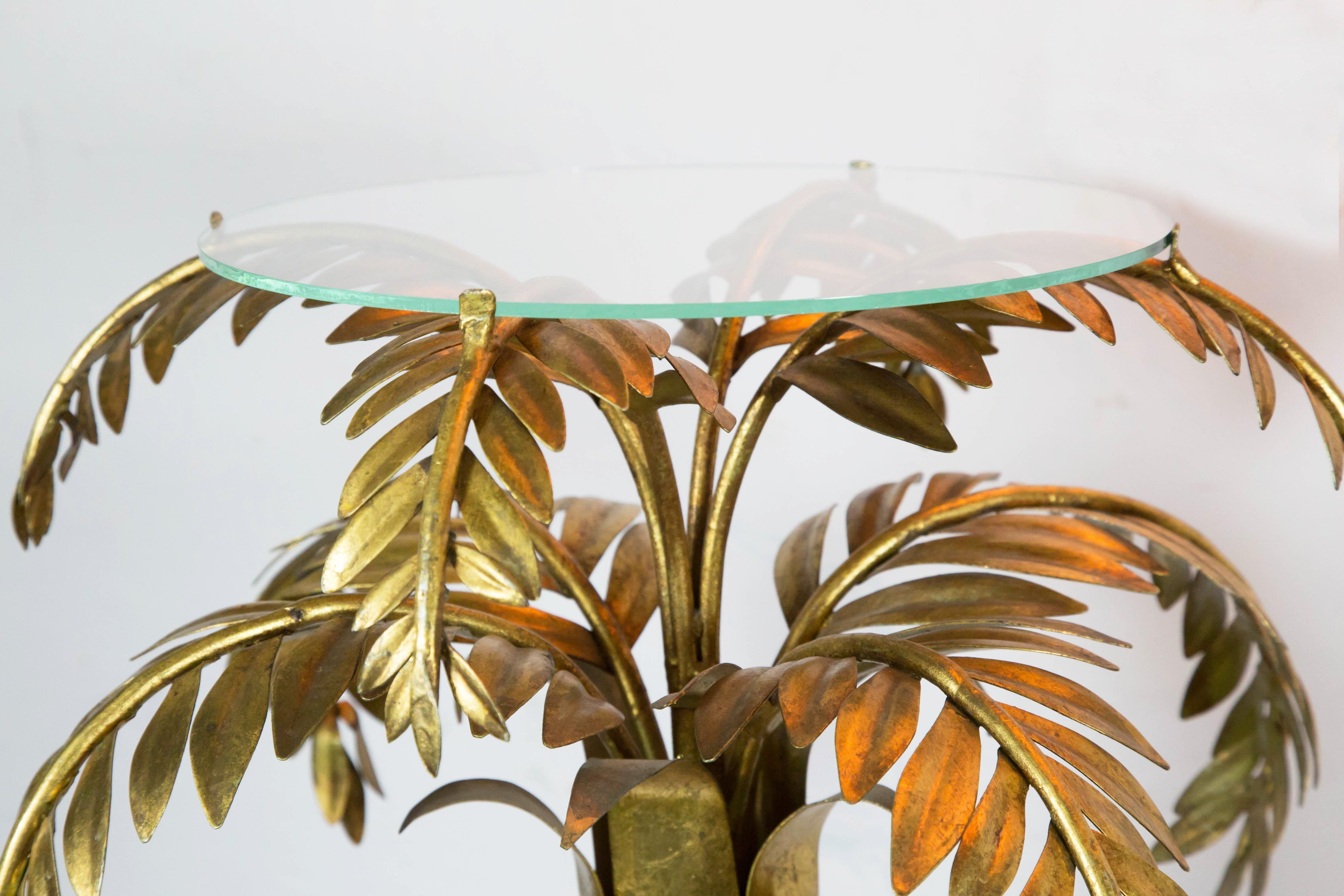 This tall Italian palm tree lamp is a large decorative piece: an excellent centerpiece for any foyer or hall. It's a gold plated, handmade iron palm tree which features 3 colored, handmade glass bulbs, lighting within and two glass shelf on top of