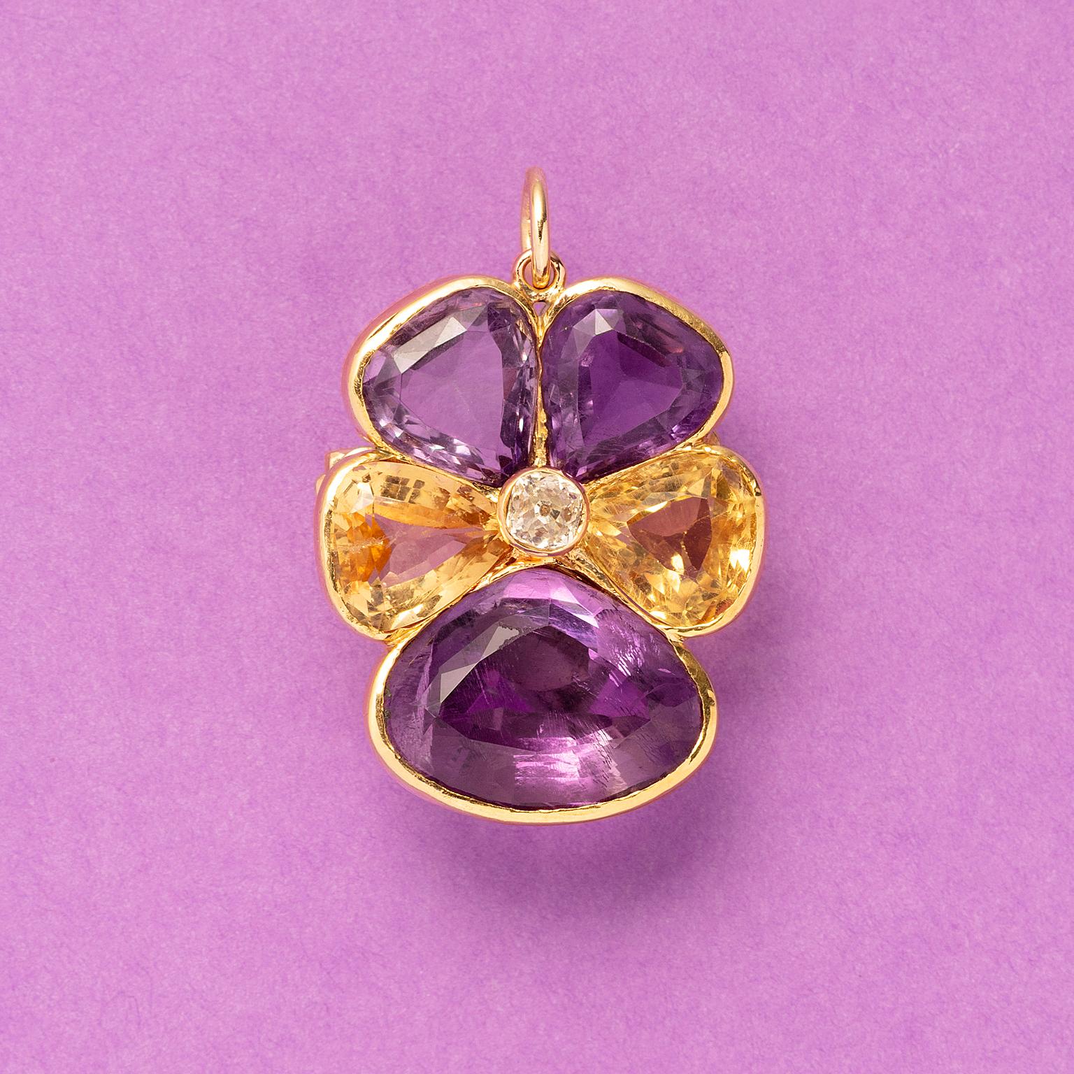 An 18 carat yellow gold pansy brooch or pendant set with three amethyst petals and two citrine petals on the sides, with a brilliant cut diamond at the heart of the flower French assay mark of a  