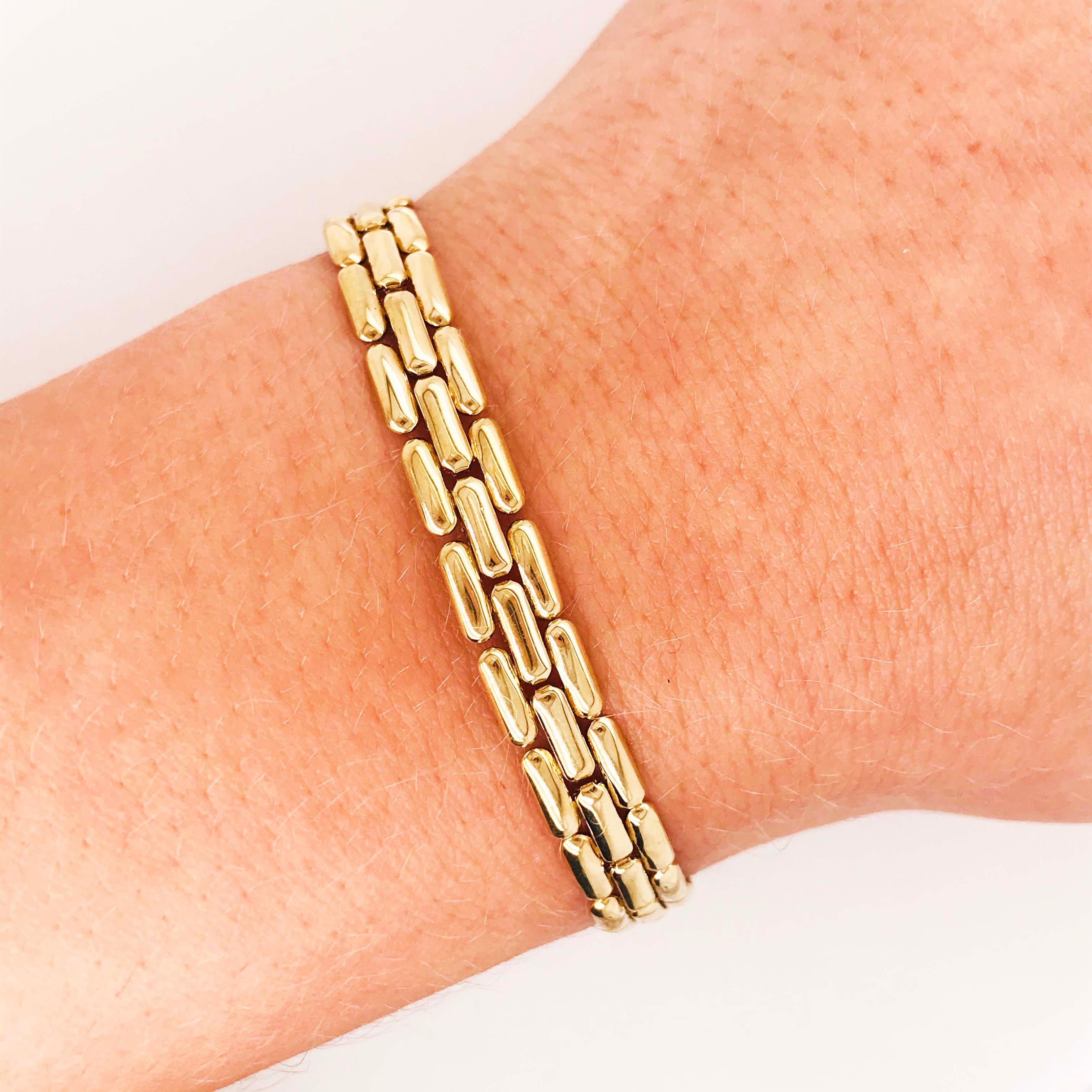 This is a genuine Panther chain bracelet with handmade links in 14k gold. The links are 14k yellow gold with white gold links in the middle. This Panther chain is a flat, smooth design that sits flat and flush on the wrist and hand. The chain is