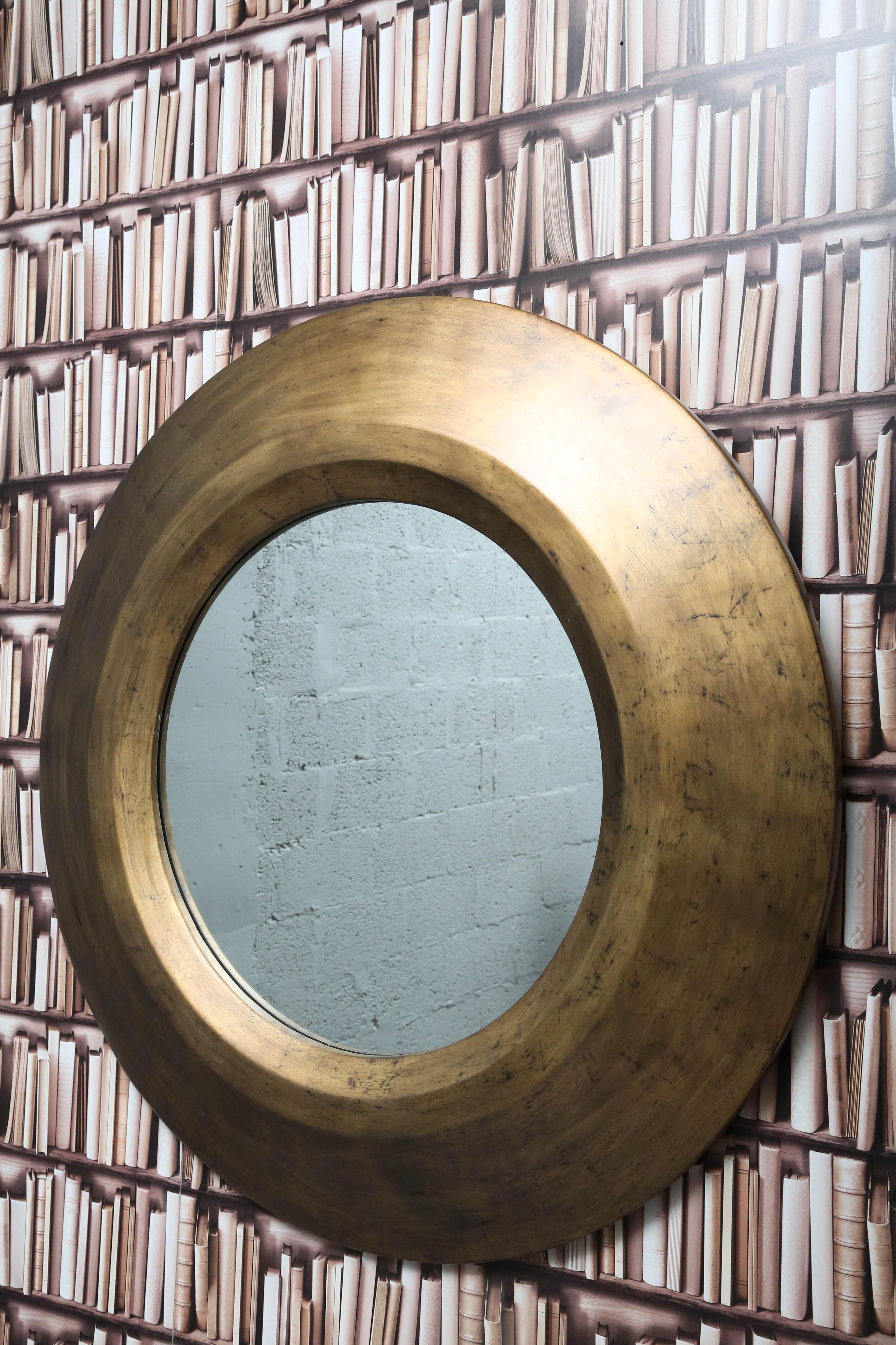 Oversized round mirror in gold by Serge de Troyer. Fabricated in Belgium.