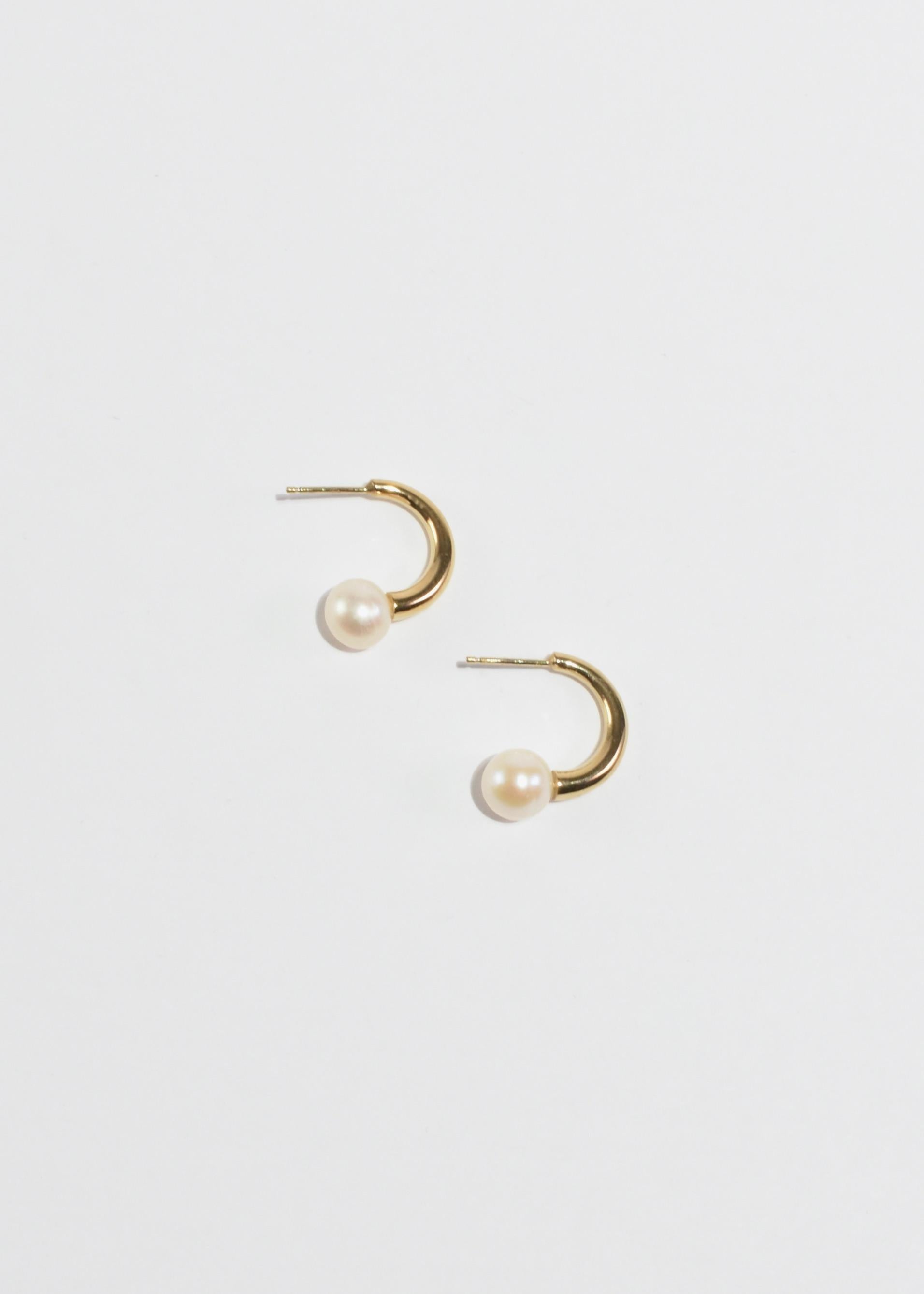 Gold semi hoop earrings with pearl detail by Sapir Bachar, pierced. Made from 24k gold plated recycled sterling silver, handcrafted in Israel. Shipped in Sapir Bachar's signature organic white twill pouch with black leather cord.

Material: 24k