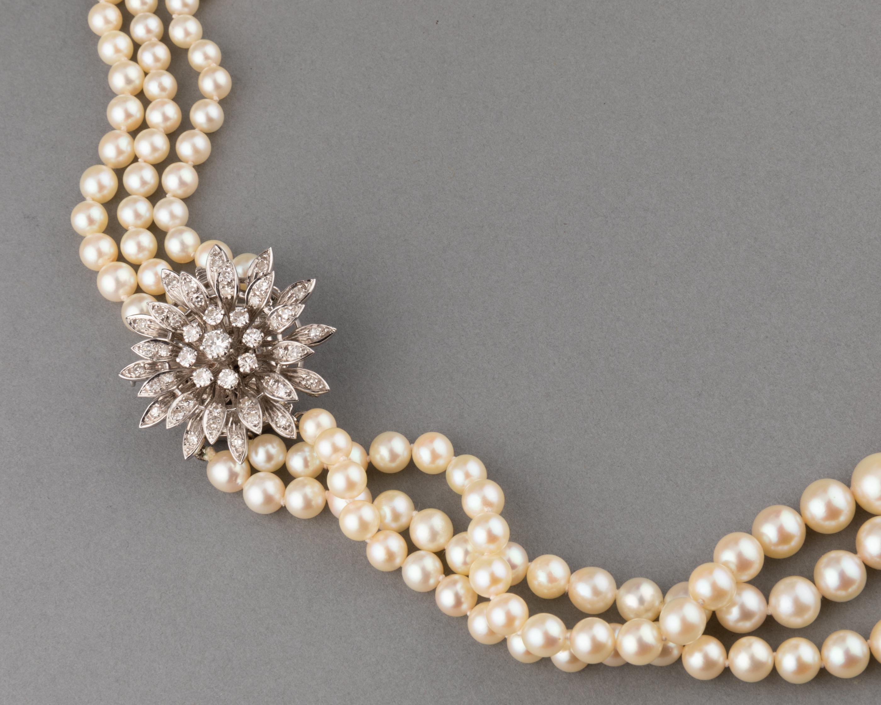 Very lovely vintage necklace, made in France circa 1960.

Made in white gold 18k, cultural sea pearls and 1.80 carats of diamonds. The pearls are in very good condition. Diameter of pearls are from 5 to 8 mm.
Mark for gold 18K: the eagle head. Mark