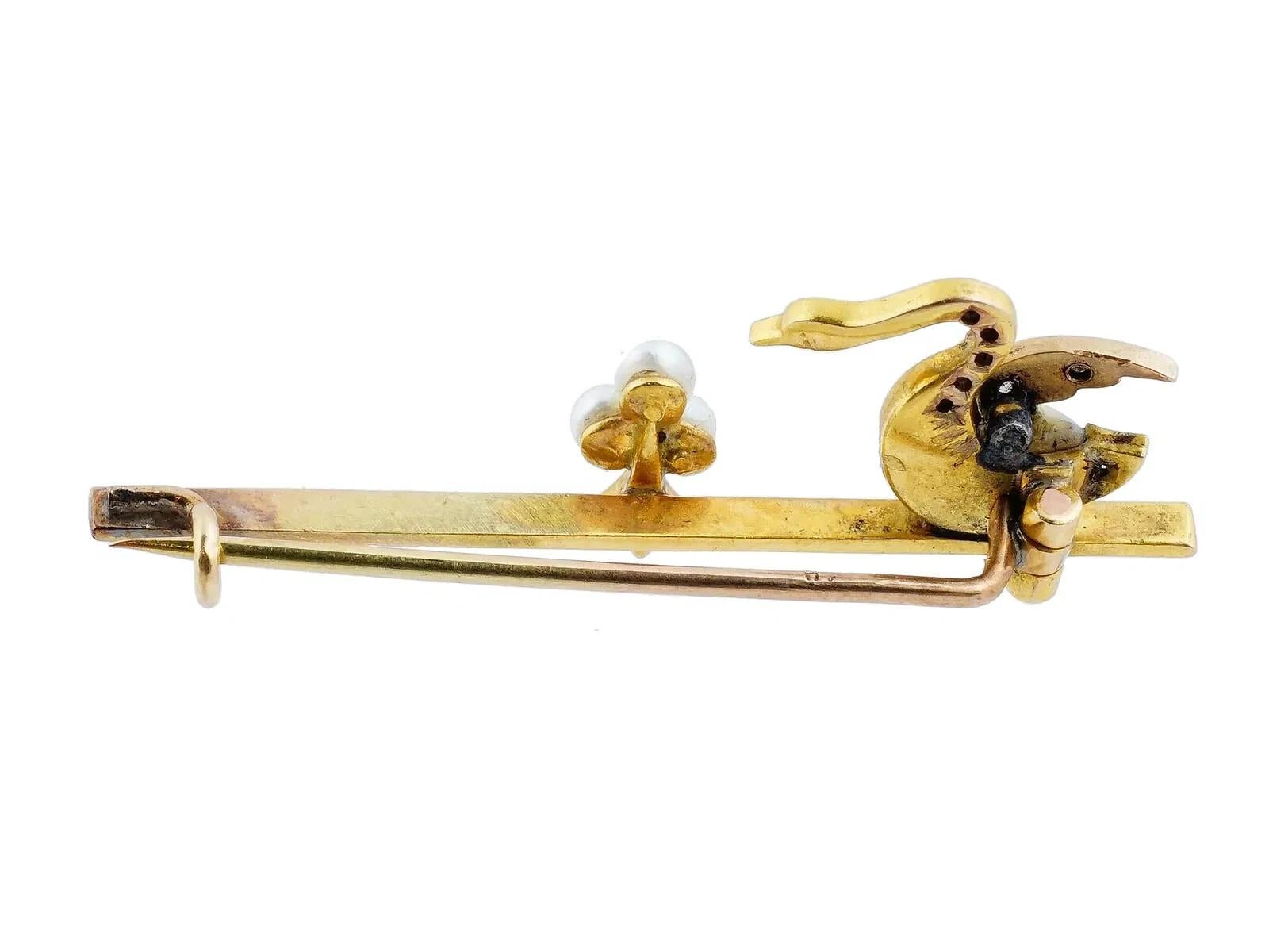 A vintage Gold sculptural brooch. The brooch is adorned with pearls and a figural element made in the shape of a swan with a pearl body. The brooch is encrusted with stones. Vintage and Mid century Carved Stones Jewelry Wares and Accessories For