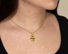 Gold Pendant with Rhodolites Topaz and Diamonds