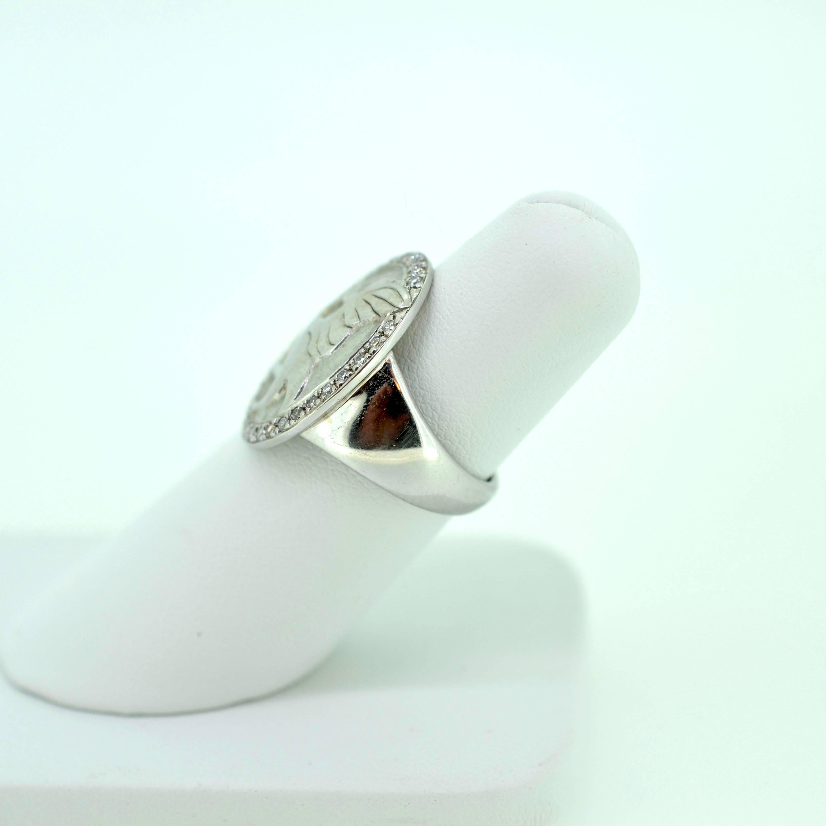 Phoenix ring;  hand carved and cast in 14 kt white gold.  The ring has an oval surface,  21mm x 18 mm in size and completely rimmed with full cut diamonds.    .50 ct. TW  VS clarity  G color   The ring tapers to 4.0 mm. 