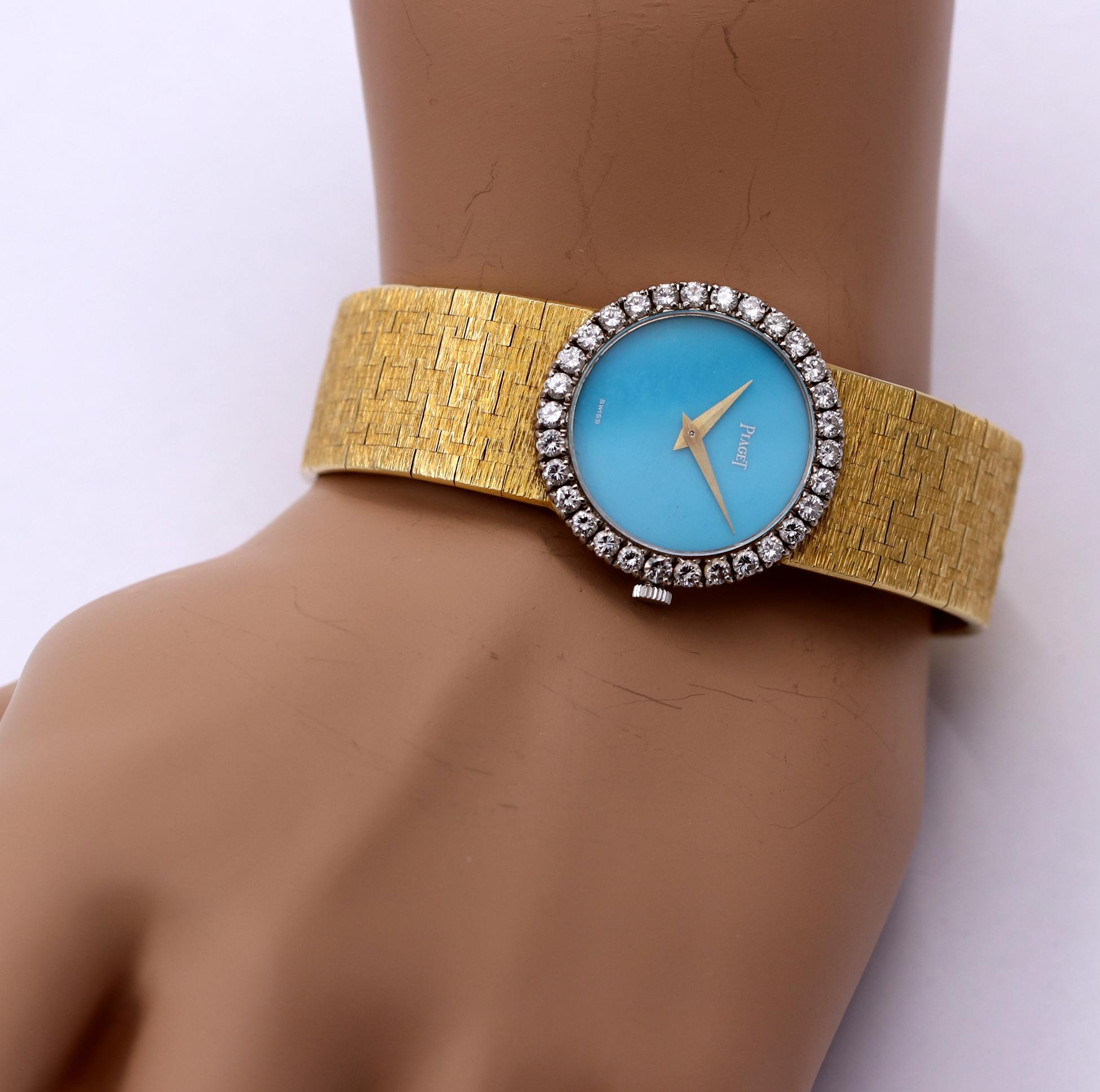 A ladies 18K yellow gold Piaget watch centered around a dial measuring 20mm in diameter. The outside of the bezel measures 27mm, and is set with 32 round brilliant cut diamonds weighing 1.65ct, total approximate weight. The dial is a robin's egg