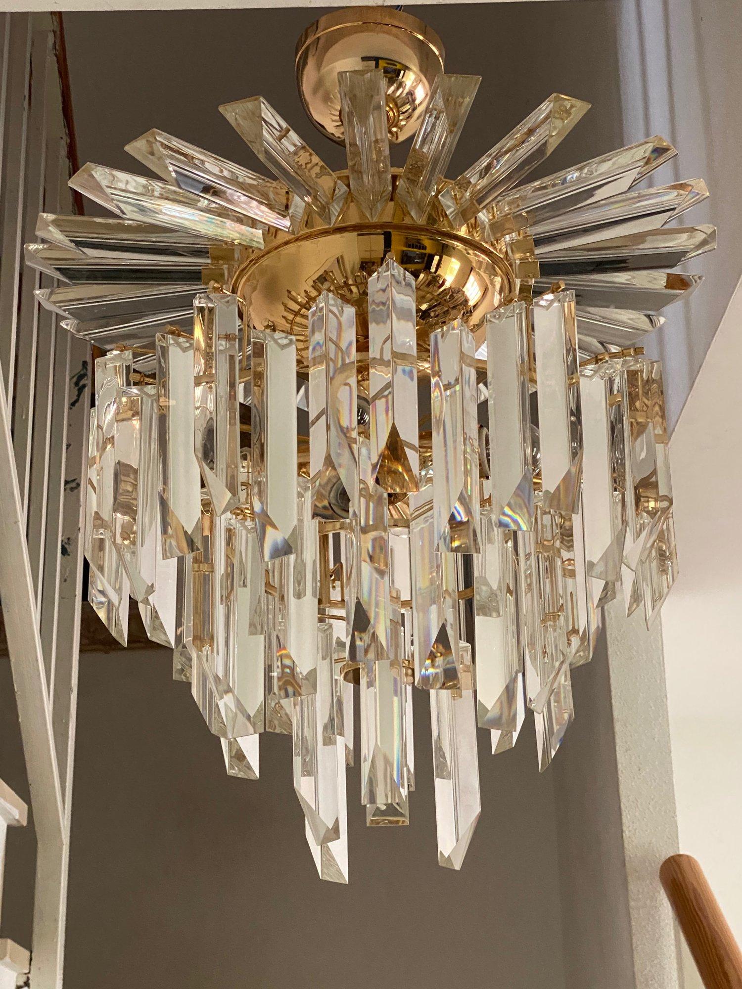 Wonderful original 1970s chandelier with crystal glass ingots.

Characteristic cascading design of glass ingots with a structure from pieces of glass hang arranged in 4 rows.
The crystals are in good overall condition, although some may have a