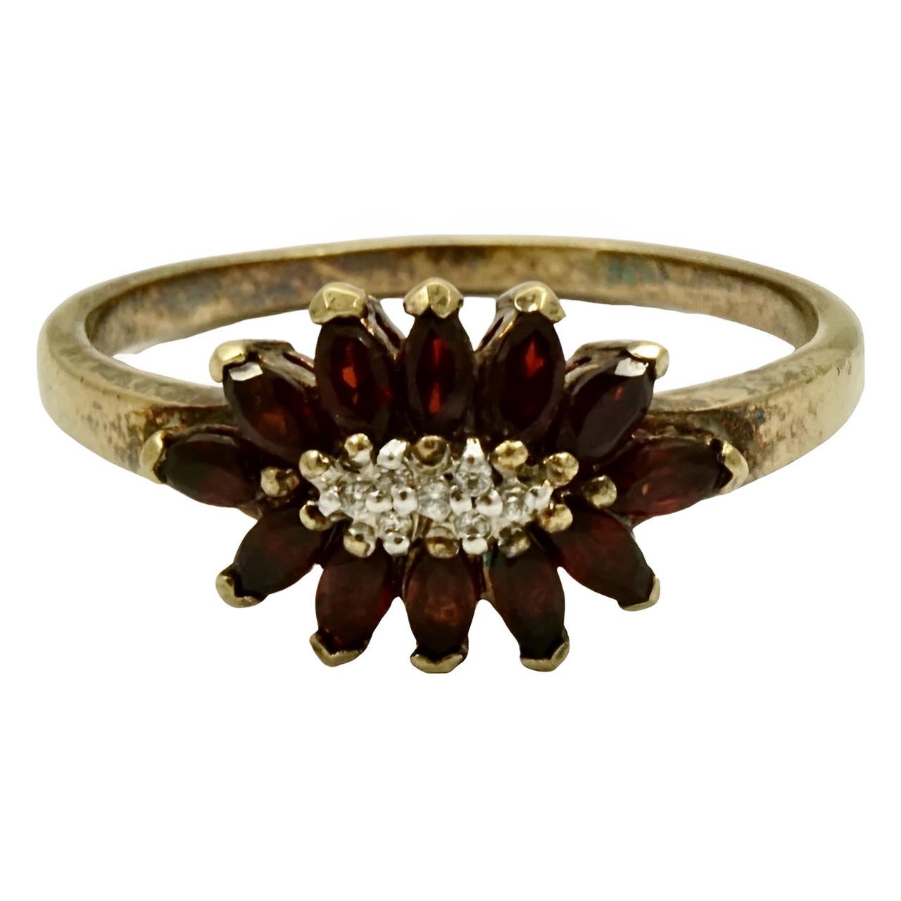 Lovely gold plated ring set with garnets, and a silver plated centre with a cluster of seven rhinestones. This is a large ring size UK V 1/2 / US 11, inside diameter 2.1 cm / .8 inch.

This is a beautiful and stylish ring that glints in the light.