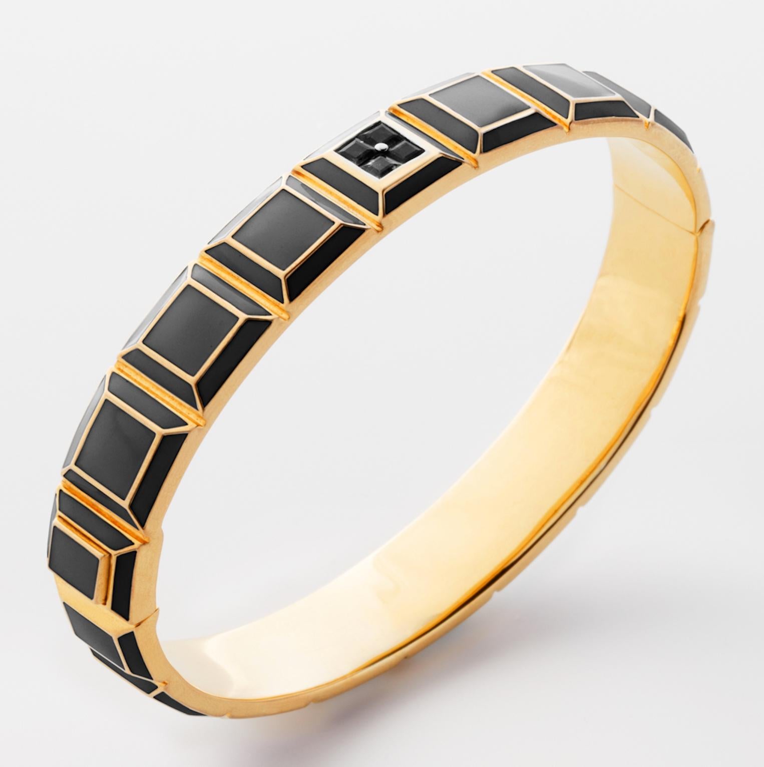 Gold-Plated Enamel Carousel Bracelet features a Yellow Gold-Plated Silver bracelet with Black Enamel and Black Diamonds, along with a clasp closure that secures the bracelet onto the wearer's wrist. 
Yellow Gold-Plated Silver, Black Enamel, Black