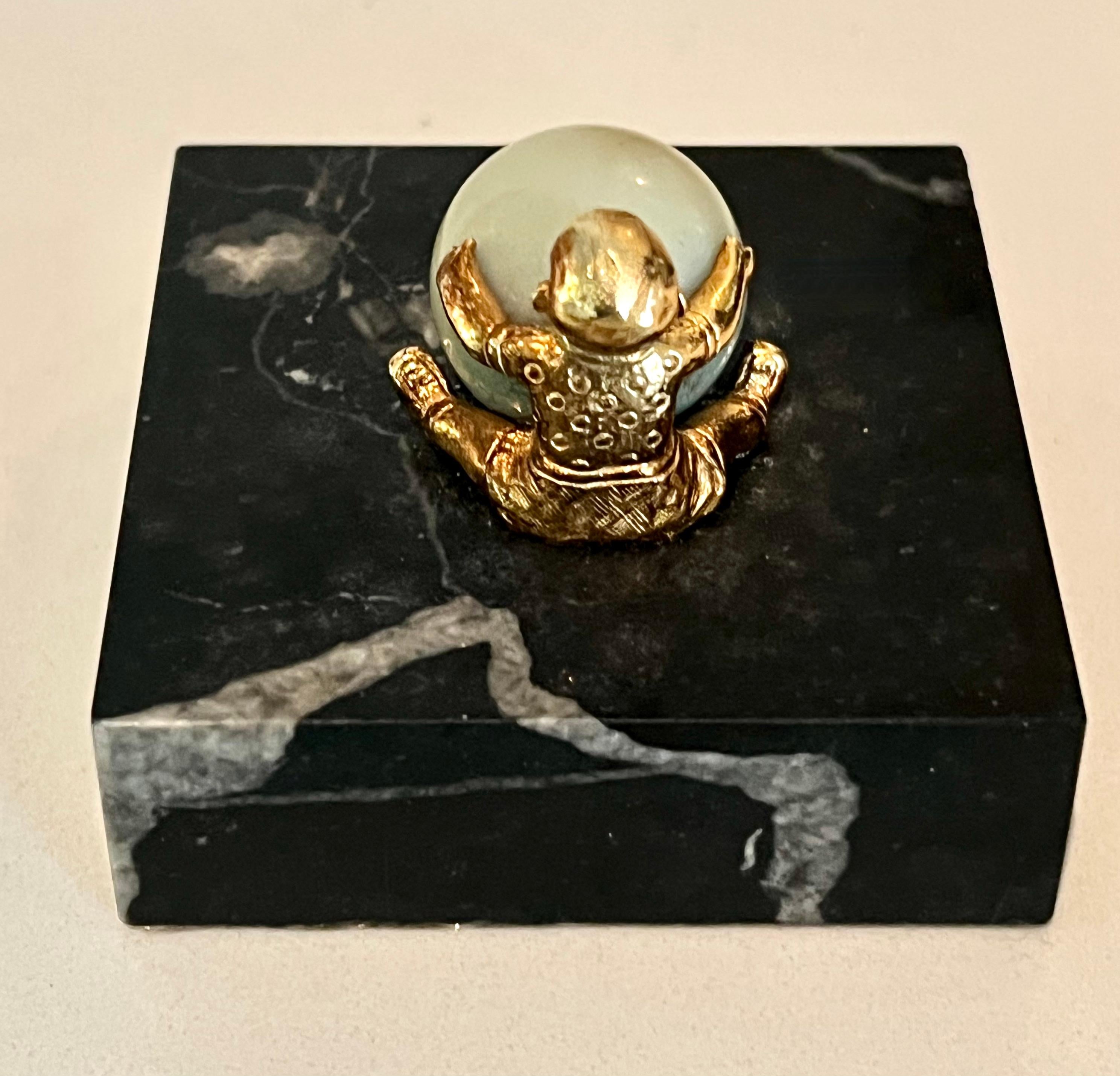 European Gold Plated Boy Holding a Large Jade Sphere on a Carrara Marble Base For Sale
