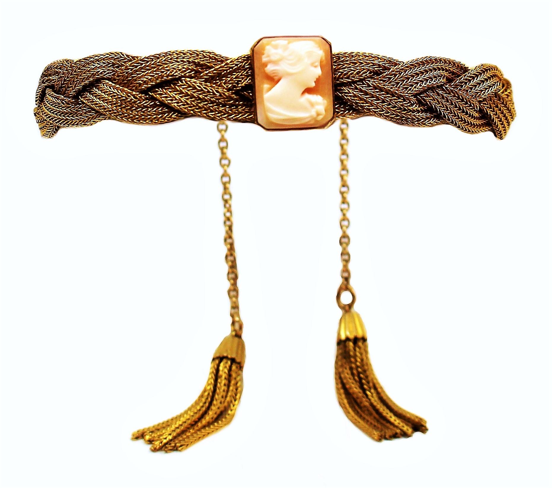 Early-20th-century gold-plated braided woven metal bracelet with a bezel set cameo and chain and tassel closure.  The bracelet is adjustable from 6