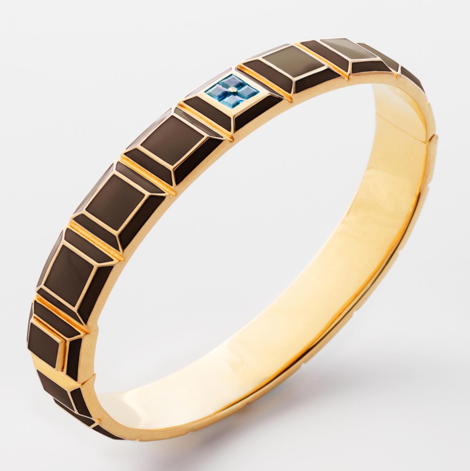 Gold-Plated Enamel Carousel Bracelet features a Yellow Gold-Plated Silver bracelet with Brown Enamel and Aquamarine Stones, along with a clasp closure that secures the bracelet onto the wearer's wrist. 
Yellow Gold-Plated Silver, Brown Enamel,